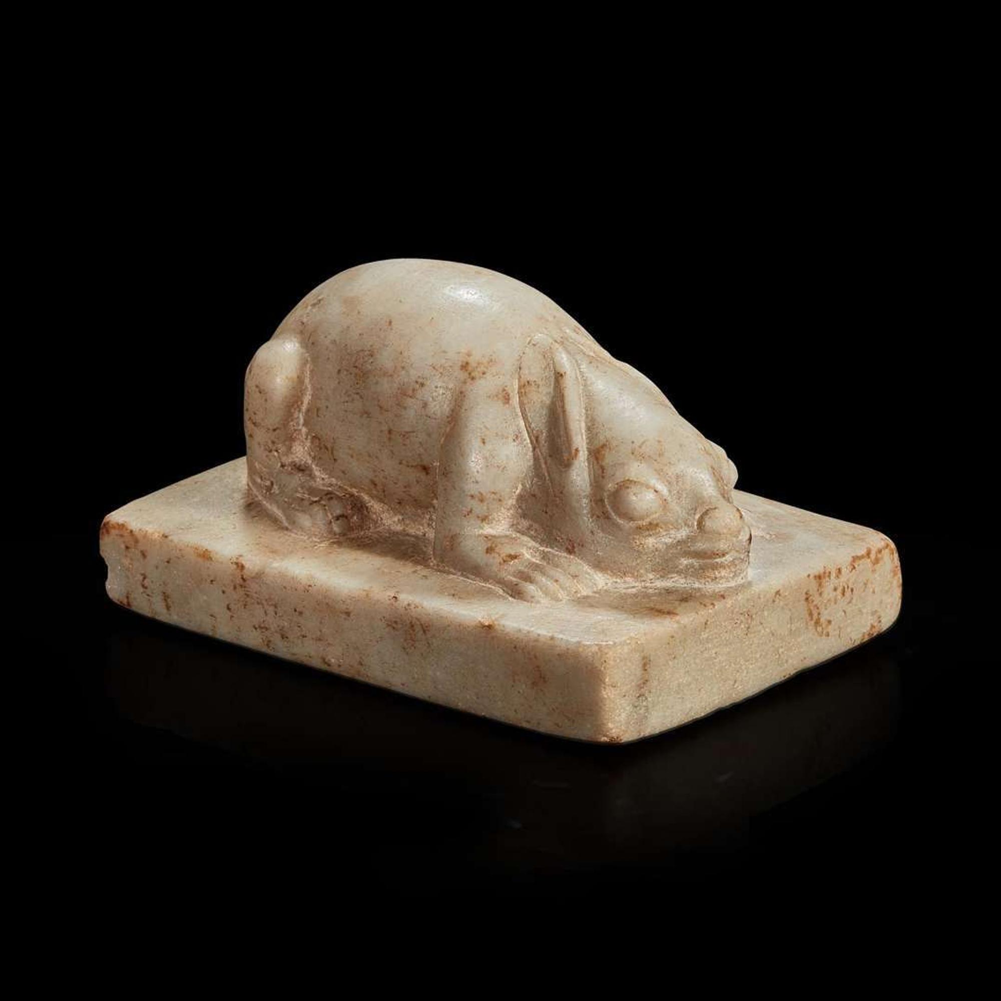 A Chinese white marble figure of a crouching rabbit Tang dynasty or later