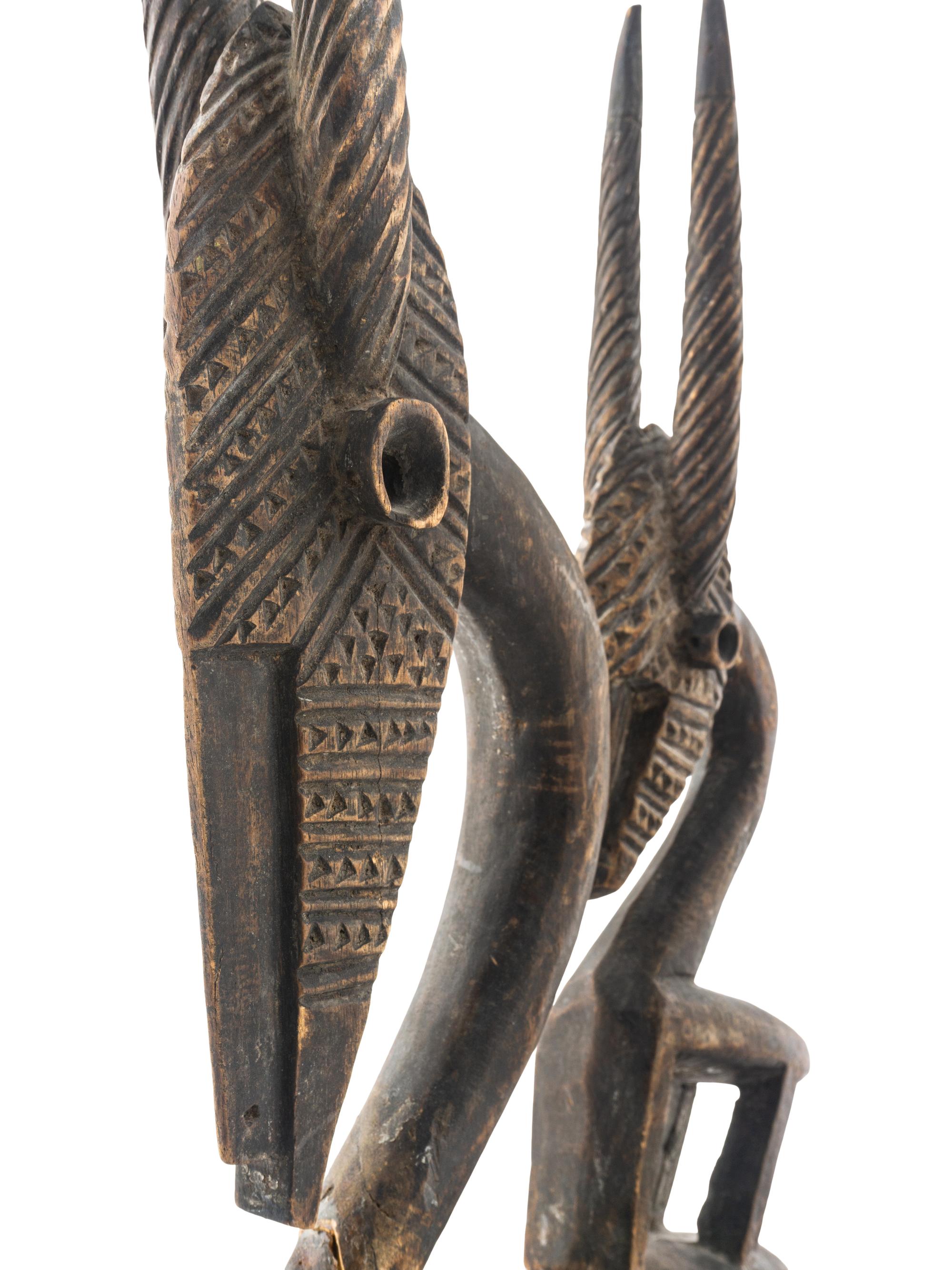 An African Wooden Figure with Bird Headdress