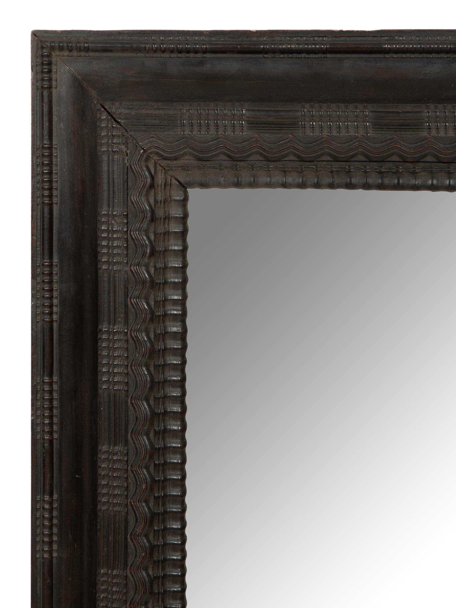 A Continental Ebonized Cushion Mirror