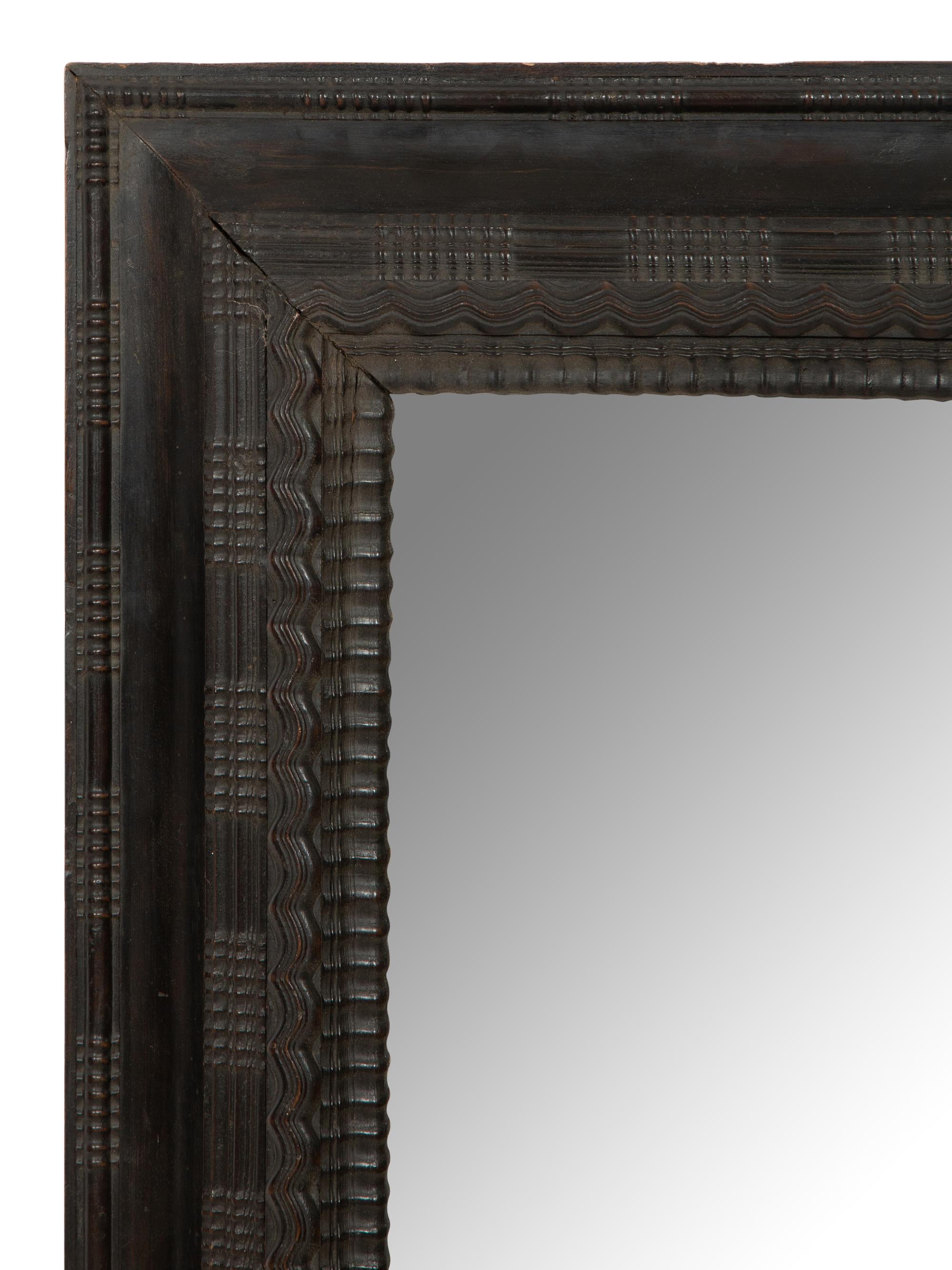 A Continental Ebonized Cushion Mirror