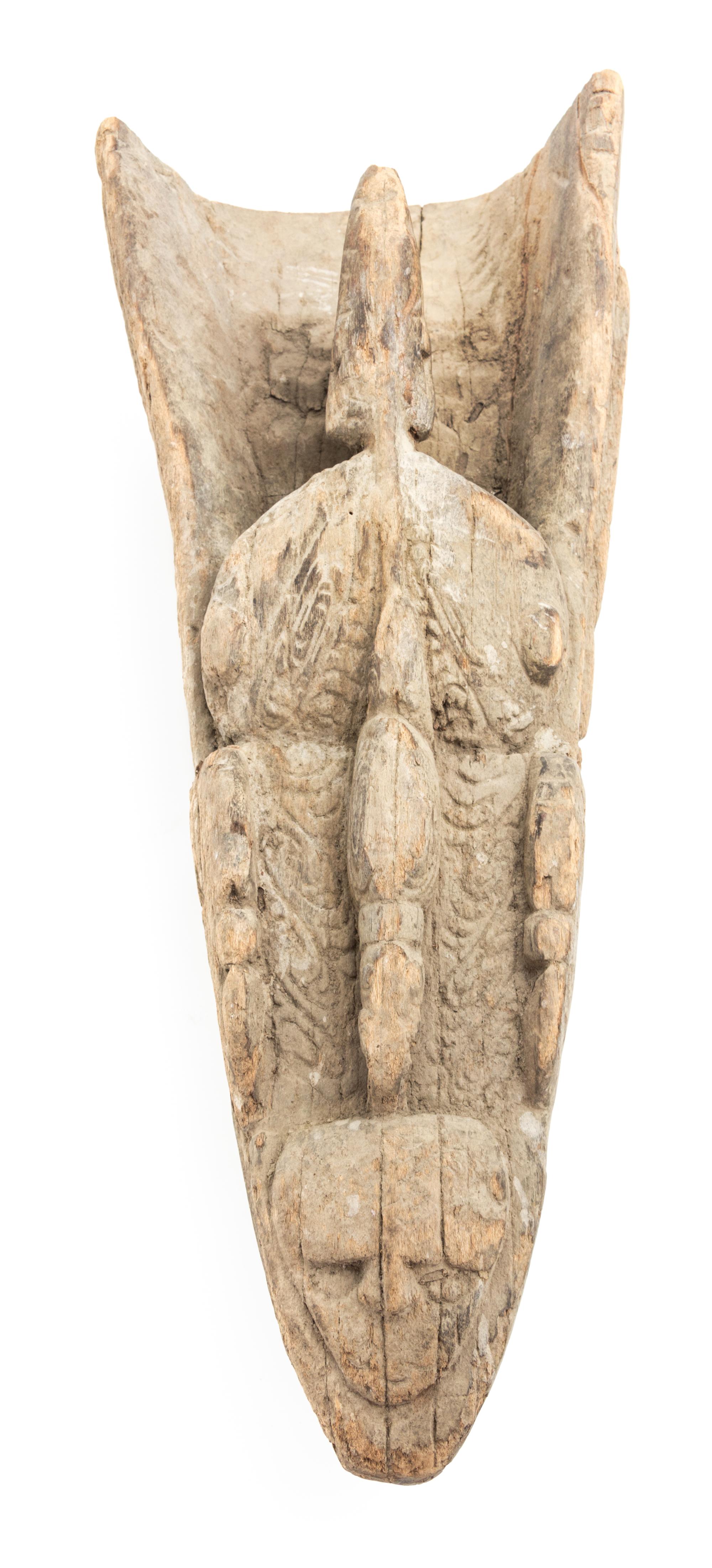 An Oceanic, Sepik River Canoe Prow from Papua New Guinea. Length 23 1/4 x width 10 1/4 x depth 6 1/2 inches.