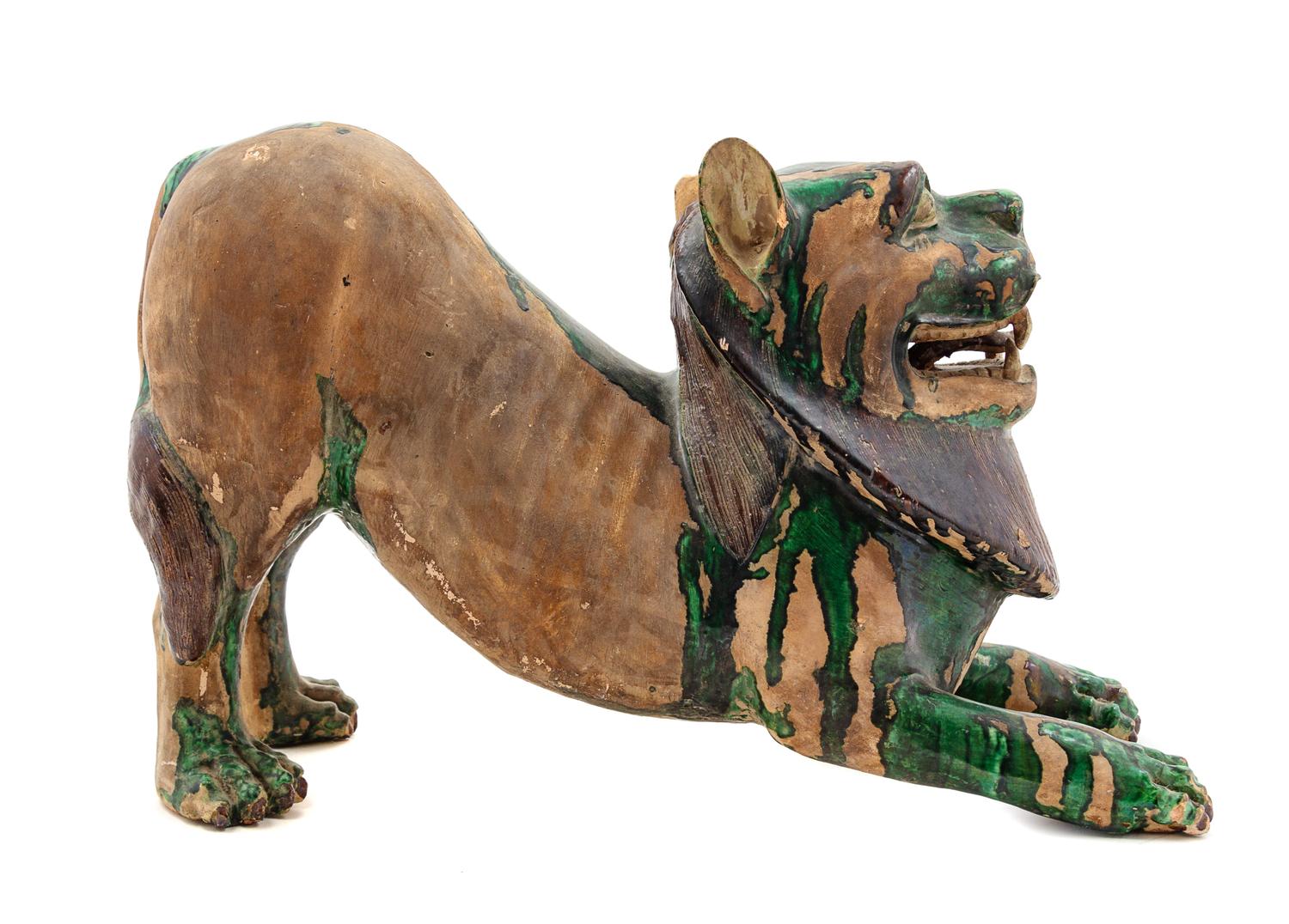 A Chinese Green and Straw Glazed Pottery Figure of a Fu Lion