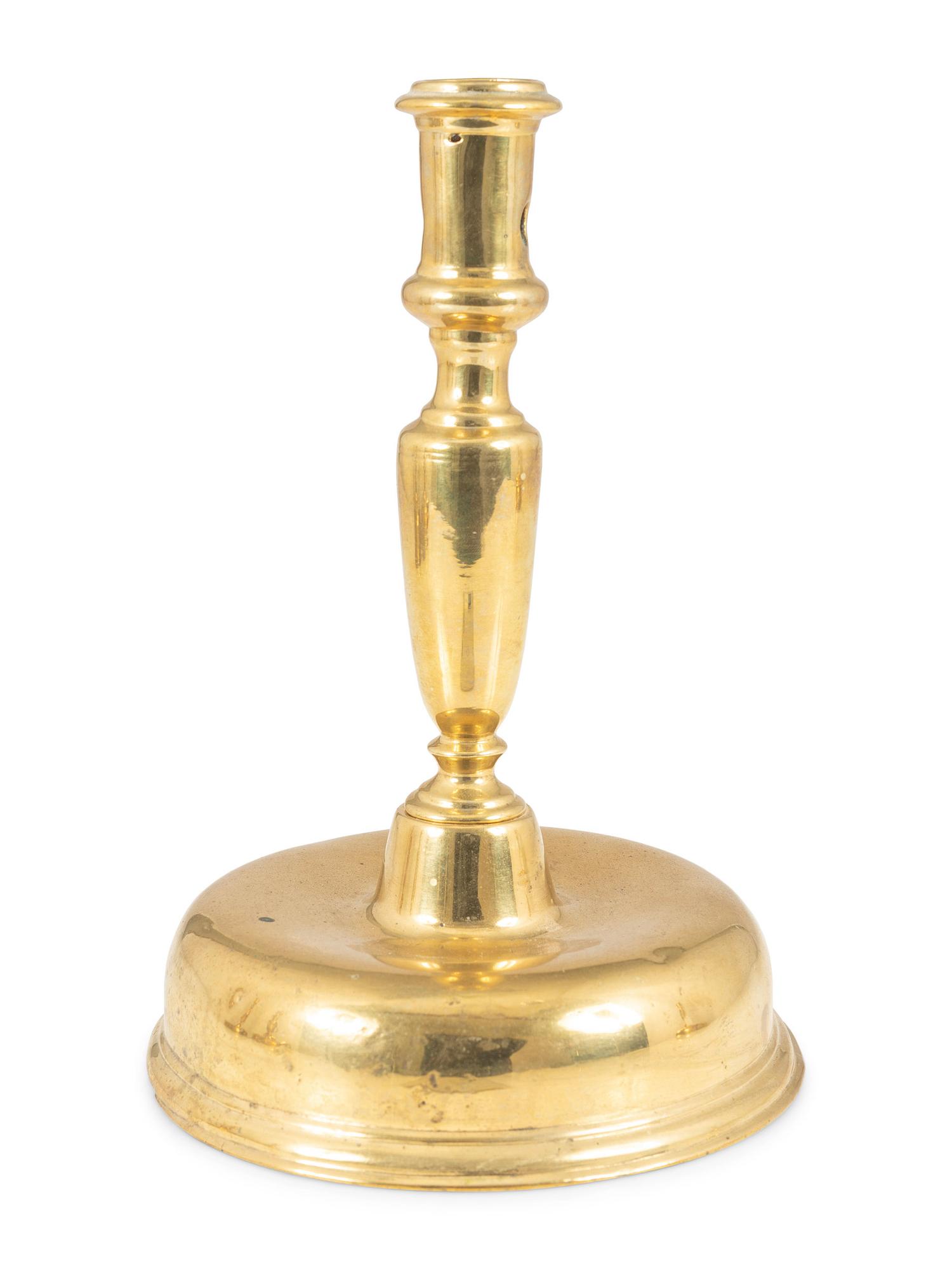 A Continental Brass Bell-Bottom Candlestick