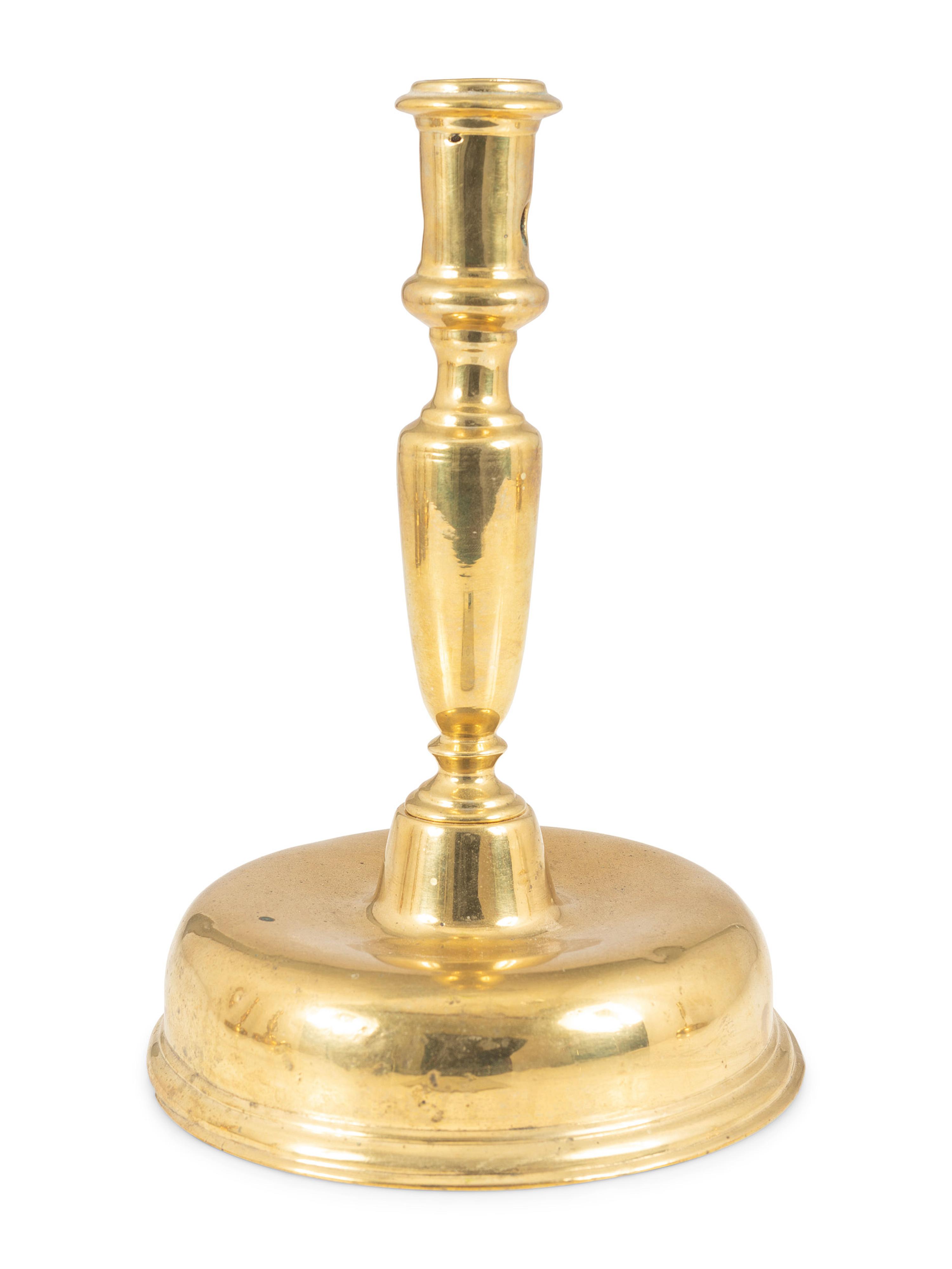 A Continental Brass Bell-Bottom Candlestick