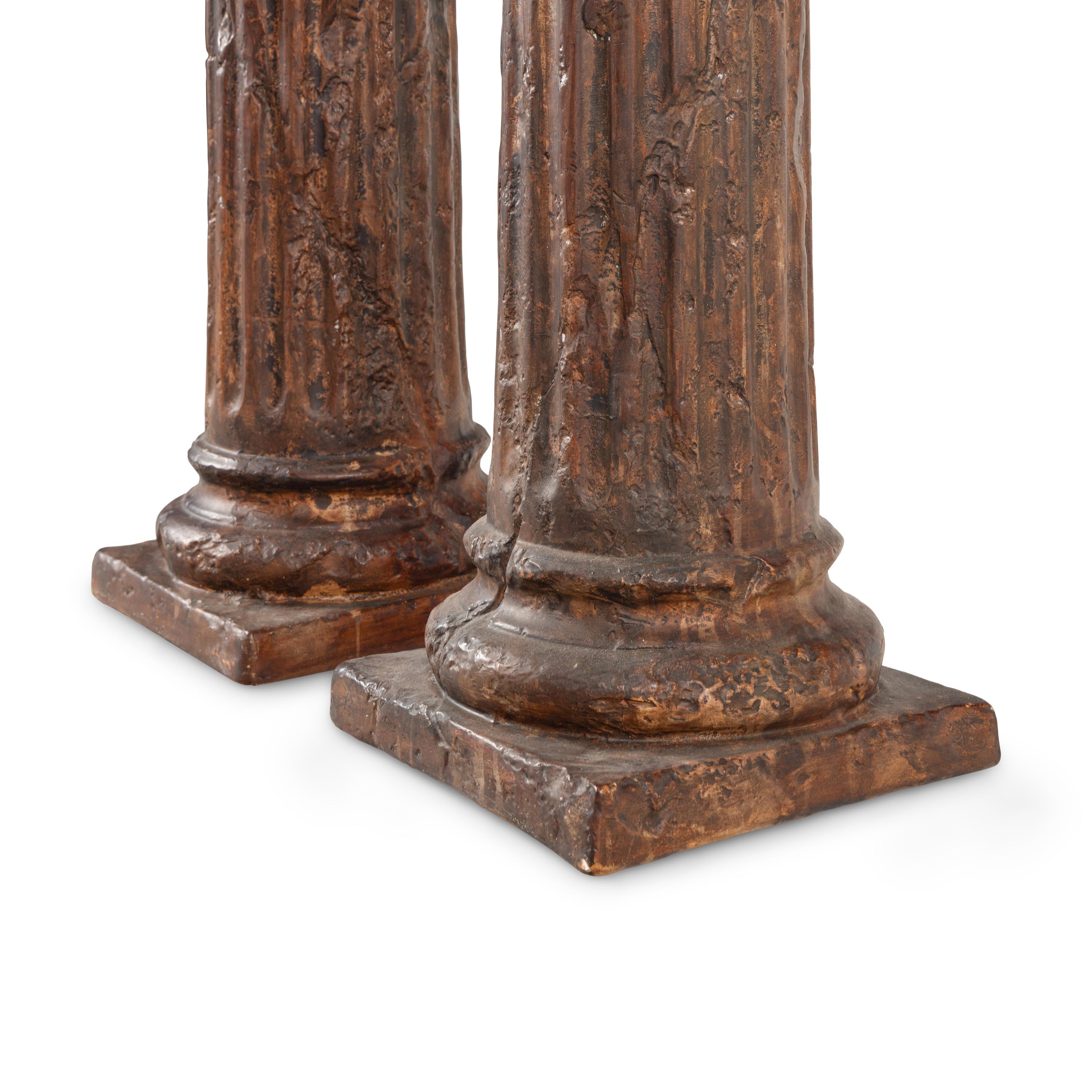 A Pair of Silvered Wood Urn-Form Finials on Painted Columnar Pedestals