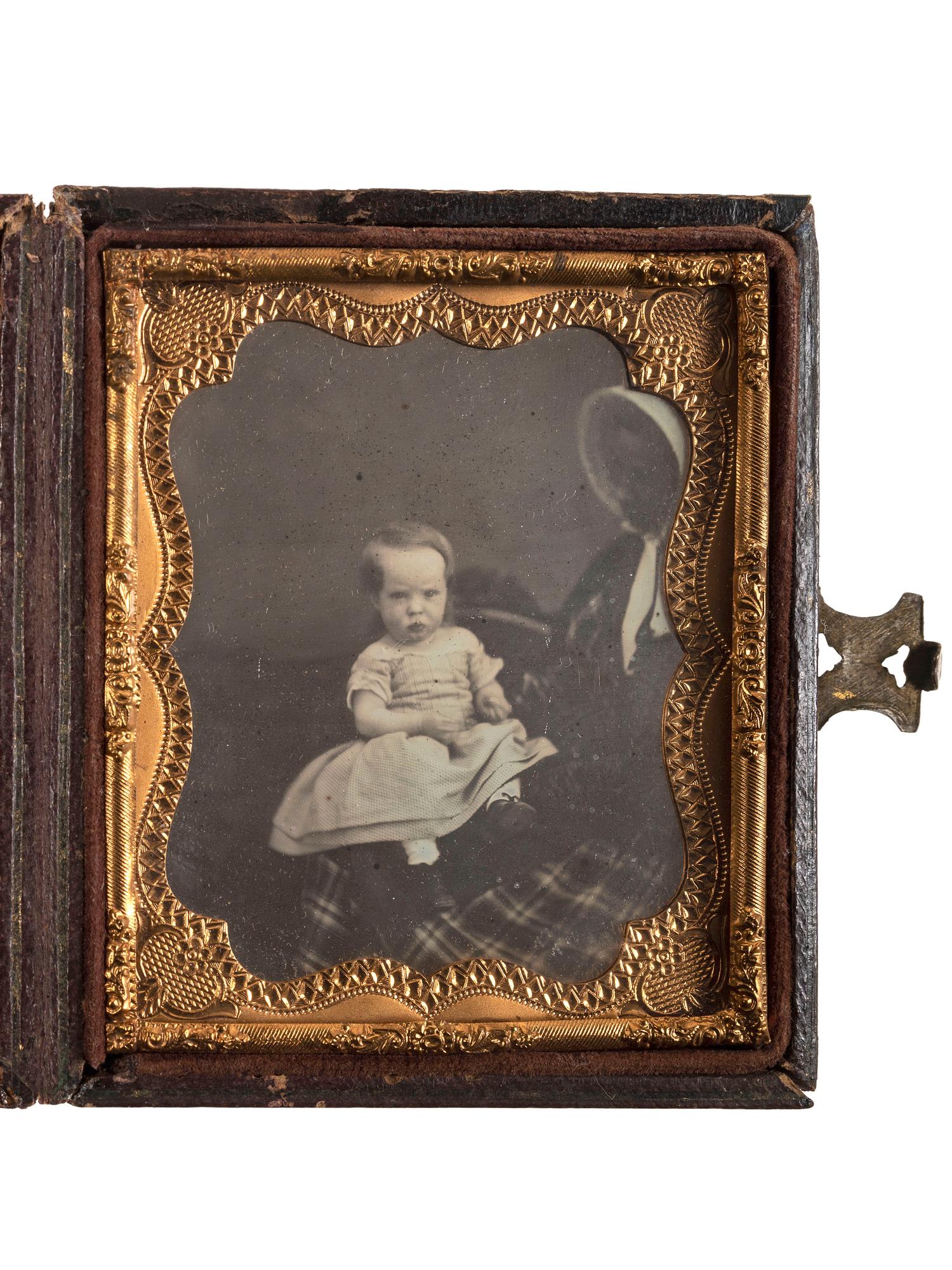 [EARLY PHOTOGRAPHY]. Sixth plate daguerreotype of white child being held by partially obscured African American woman.