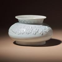 A Chinese White Glazed Molded Porcelain 'Floral' Jar, Mid Ming Dynasty, 15th Century — 明中期 白釉模印纏枝花卉敞口罐