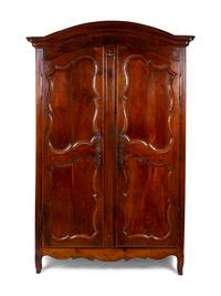 A French Provincial Carved Walnut Armoire — 19TH CENTURY