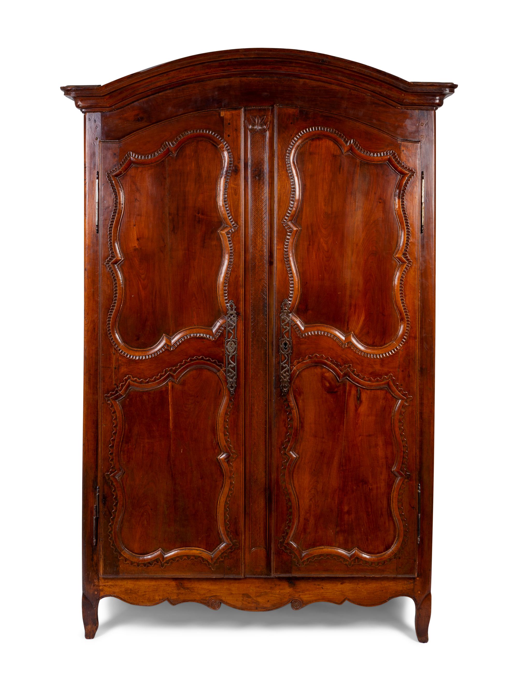 A French Provincial Carved Walnut Armoire — 19TH CENTURY
