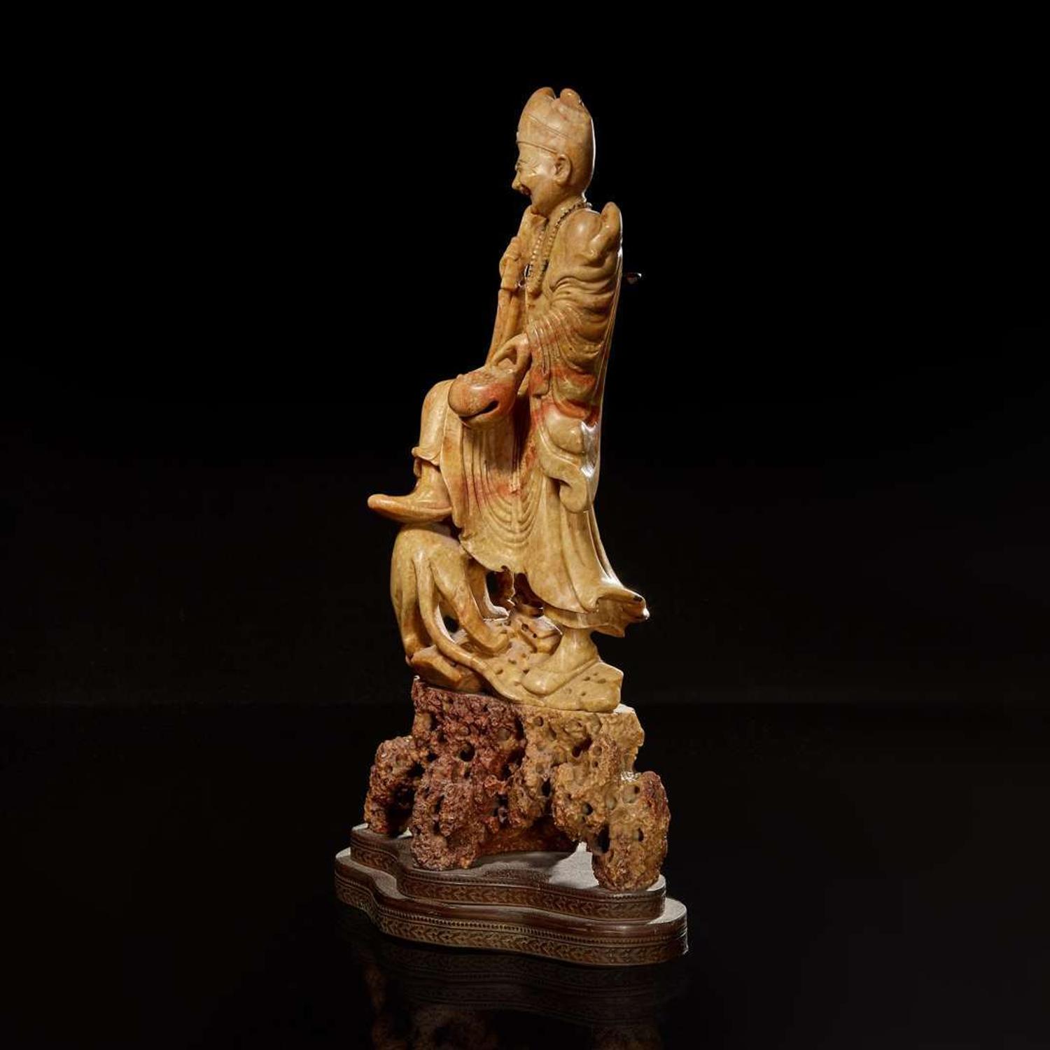 A Chinese carved beige soapstone figure of an immortal or monk with tiger 壽山石雕伏虎羅漢 Republic period or earlier ?????