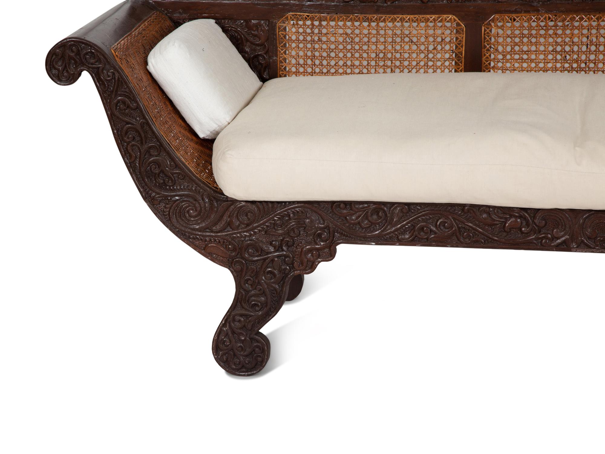 A British Colonial Carved Mahogany and Cane Work Settee