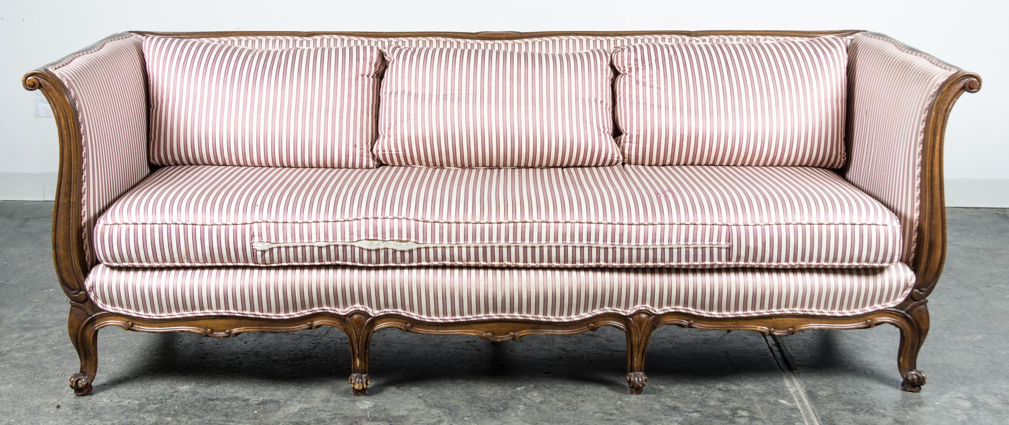 A Louis XV Style Walnut Sofa Height 29 1/2 x width 83 x depth 32 inches.