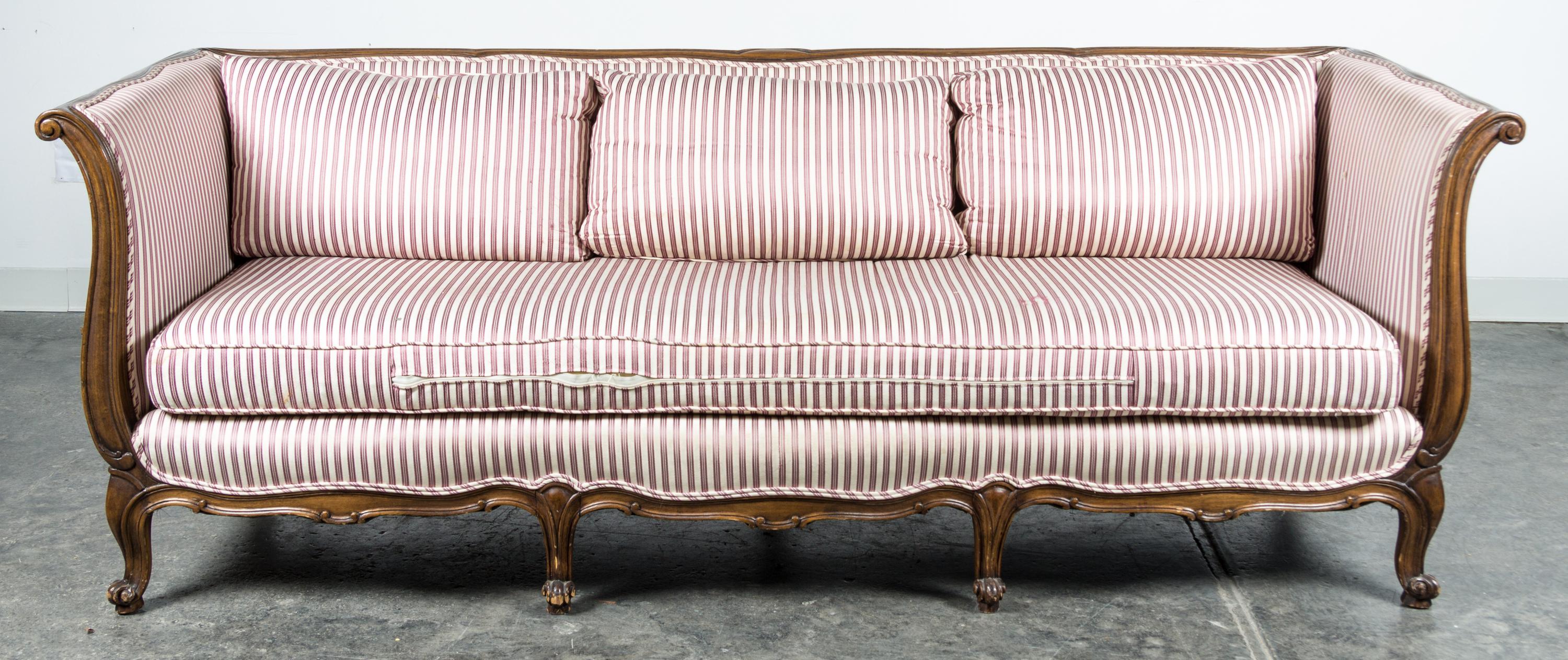 A Louis XV Style Walnut Sofa Height 29 1/2 x width 83 x depth 32 inches.