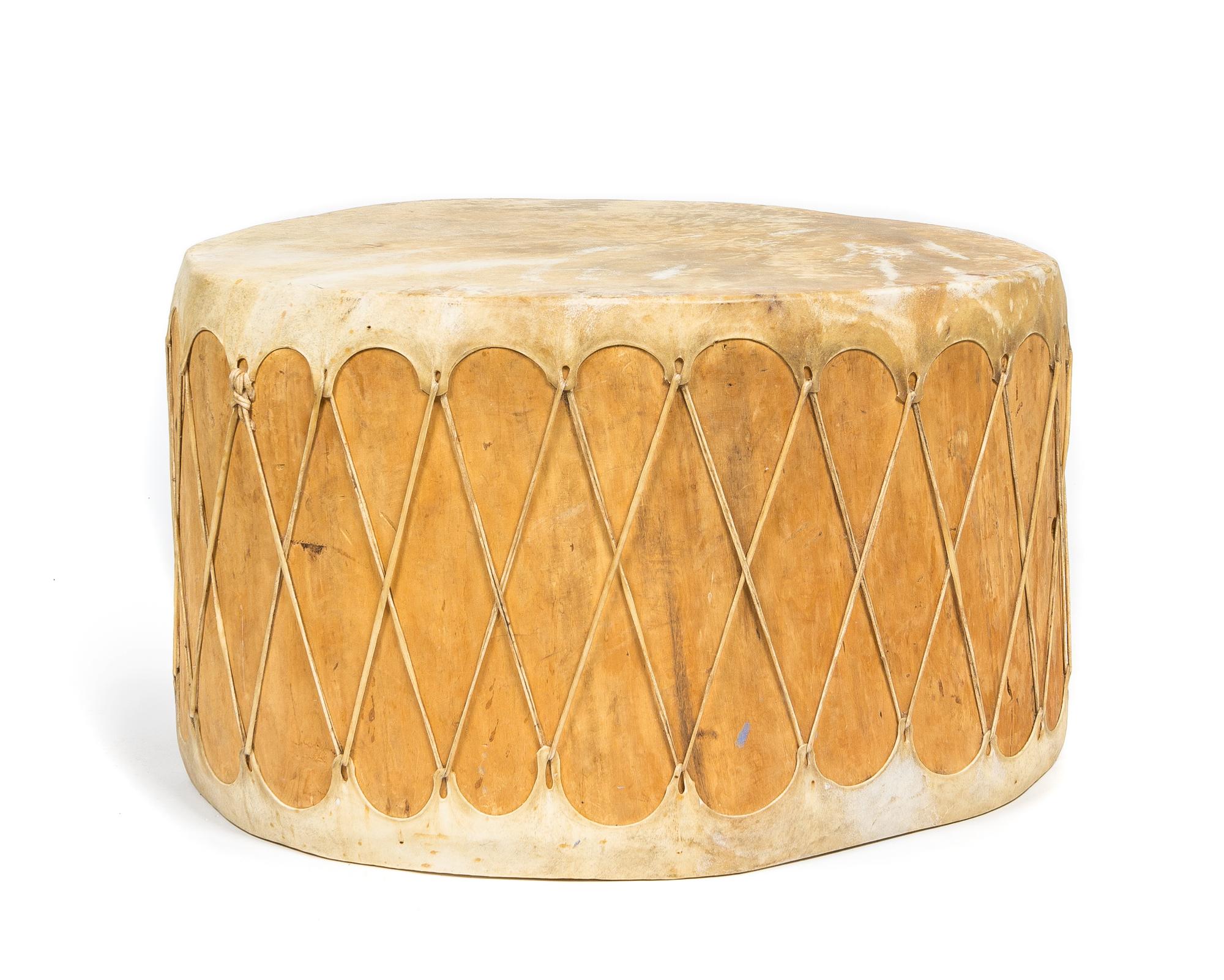 A Southwestern Hide and Wood Drum Height 18 1/4 x diameter approx. 29 1/2 inches.