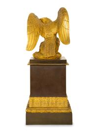 A Gilt Bronze Eagle Sculpture on an Empire Style Gilt and Patinated Bronze Base