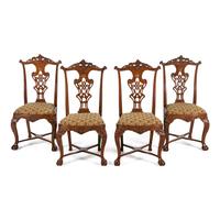 A Set of Four Portuguese Rococo Style Carved Walnut Dining Chairs