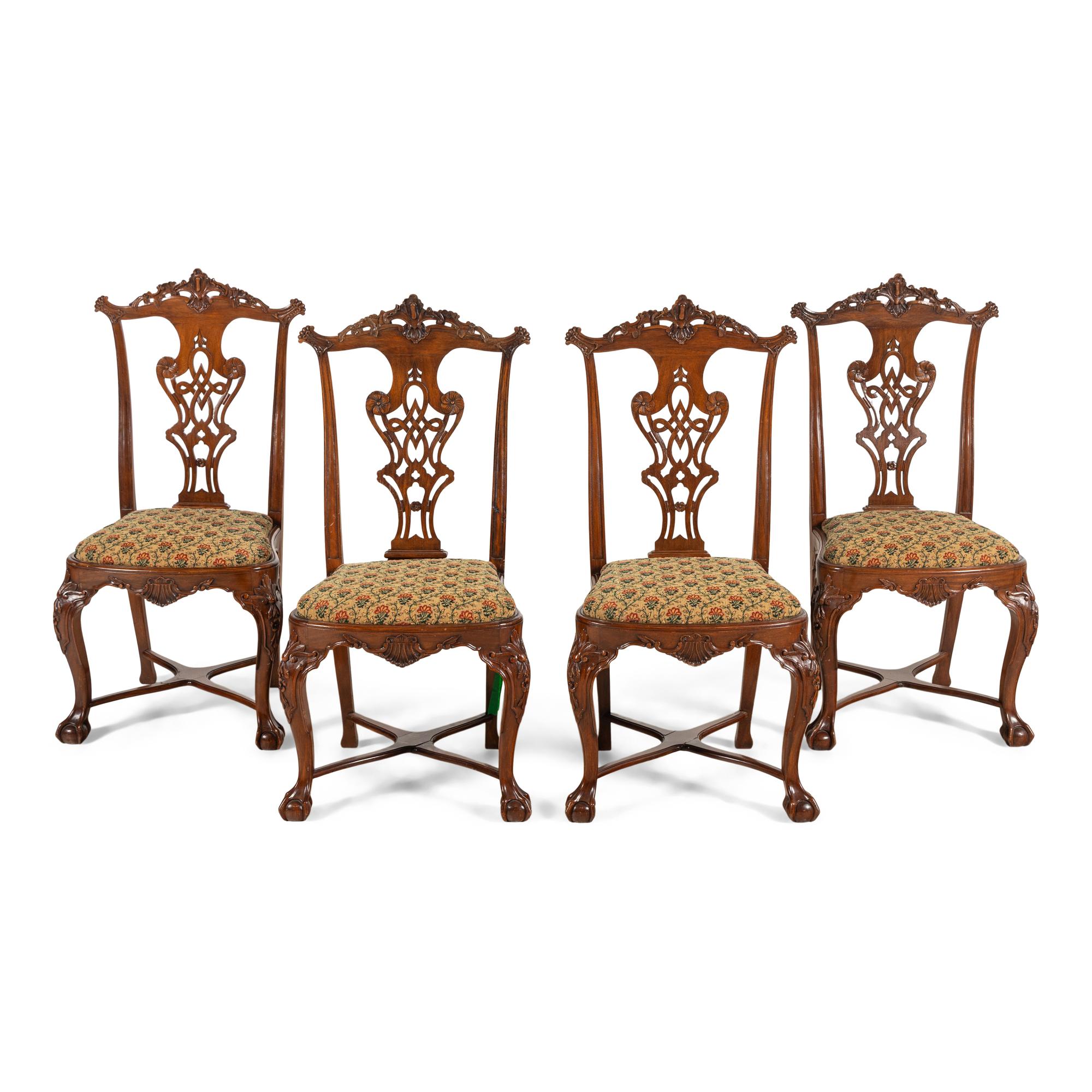 A Set of Four Portuguese Rococo Style Carved Walnut Dining Chairs