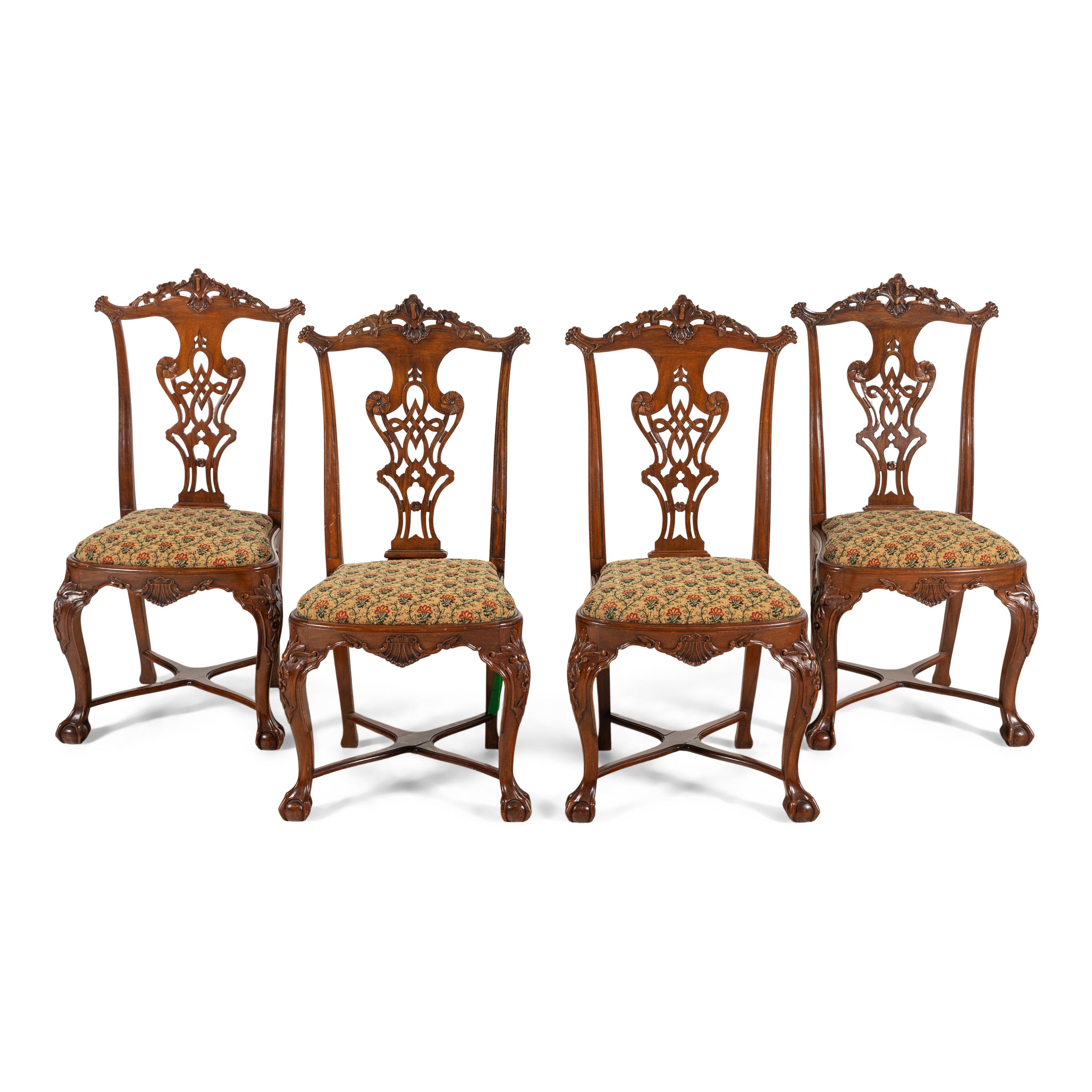 A Set of Four Portuguese Rococo Style Carved Walnut Dining Chairs