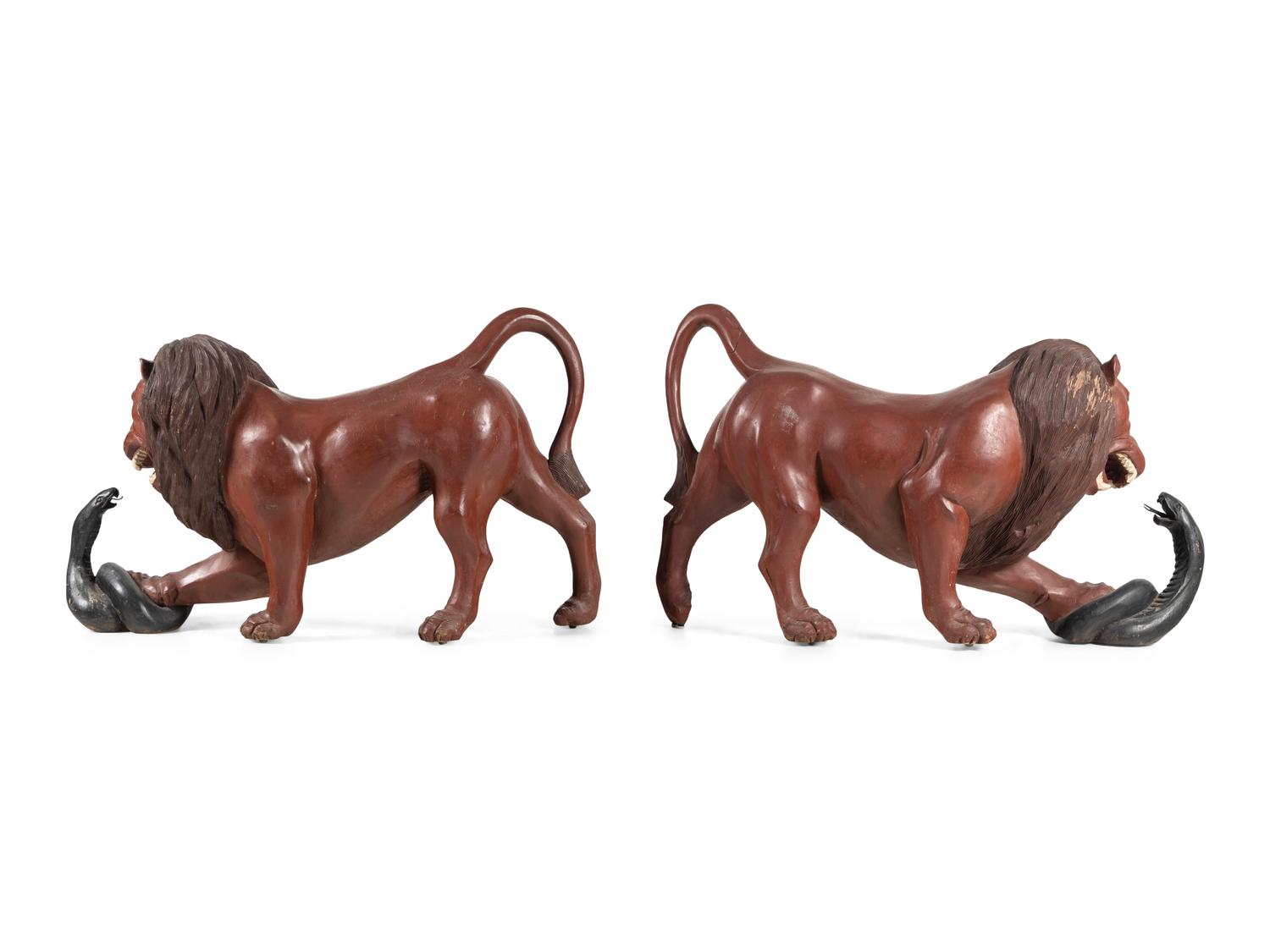 A Pair of Carved and Painted Wood Lions Wrestling Serpents