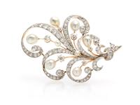 An Edwardian Platinum Topped Gold, Diamond and Pearl Brooch, 15.70 dwts.