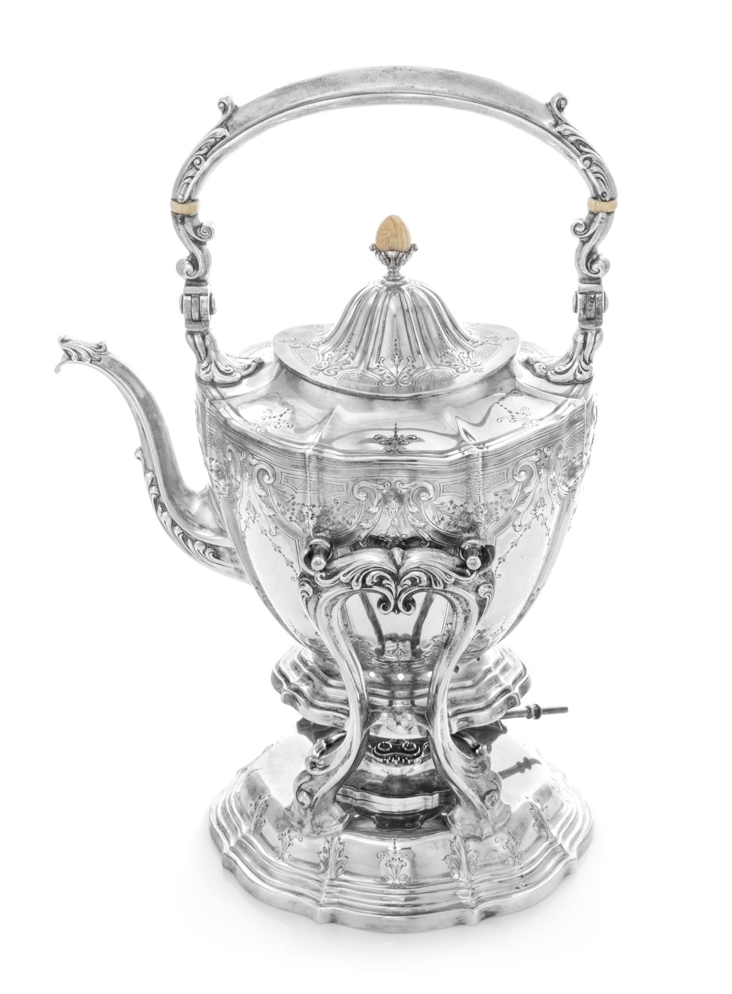 An American Silver Kettle on Lampstand, Wiilliam B. Durgin for Gorham Mfg. Co., Providence, RI, having a blossom-form finial and swing