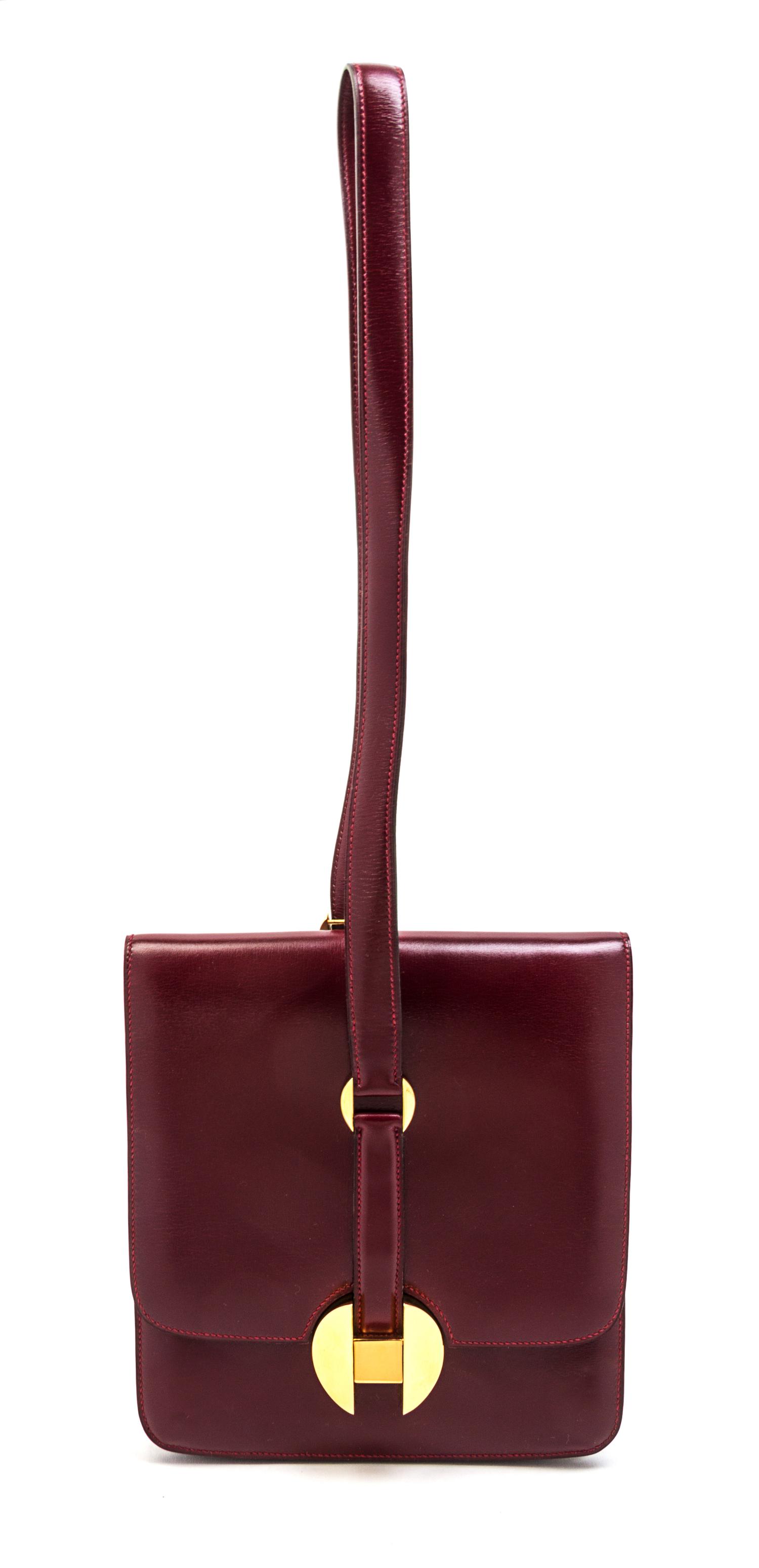 An Hermes Rouge Leather Shoulder Bag, 9 x 8 x 1 inches.