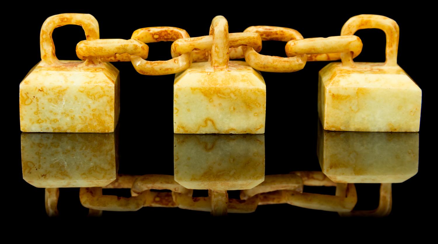 A Group of Three Celadon and Russet Jade Seals Length overall 4 inches.