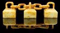 A Group of Three Celadon and Russet Jade Seals Length overall 4 inches.