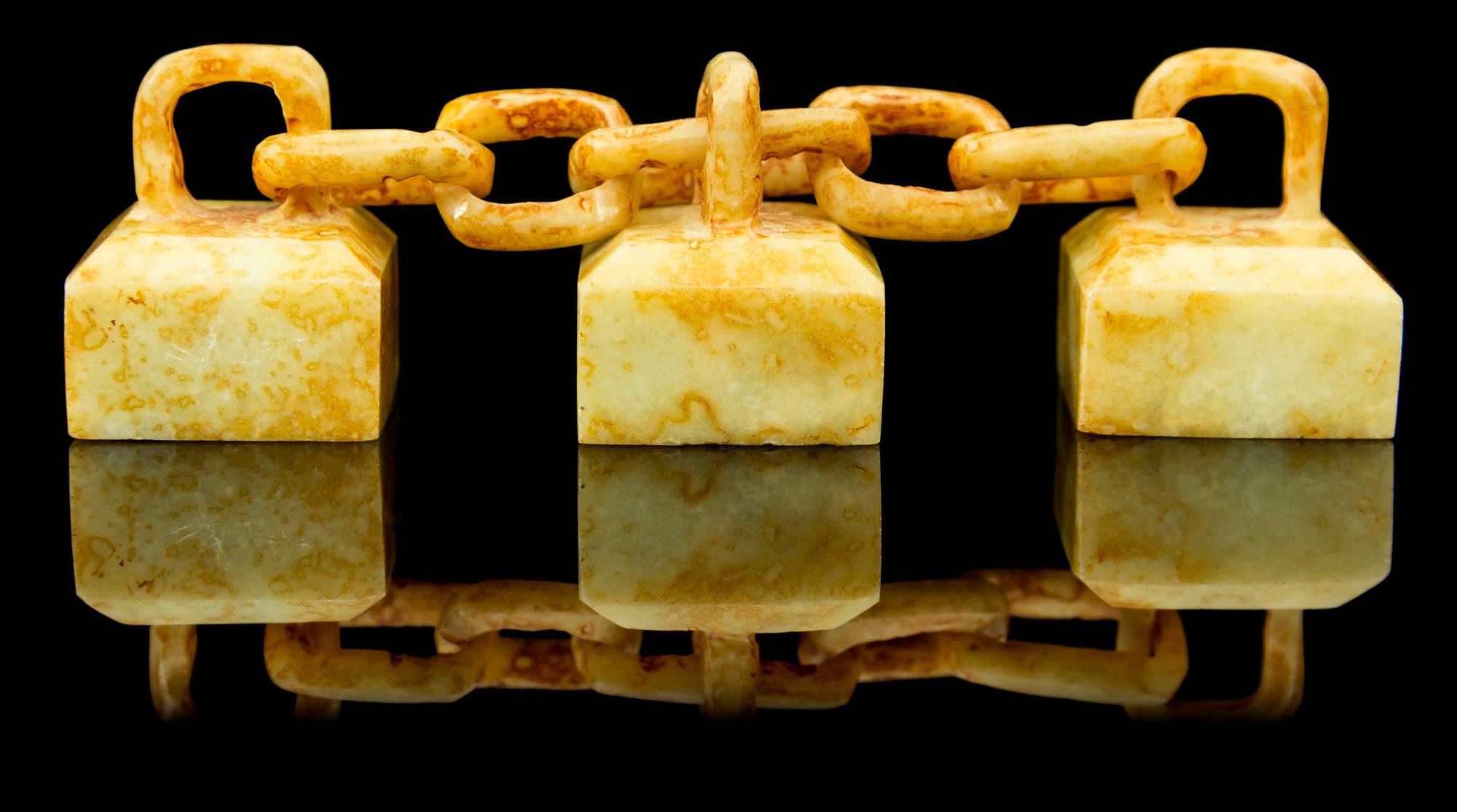A Group of Three Celadon and Russet Jade Seals Length overall 4 inches.