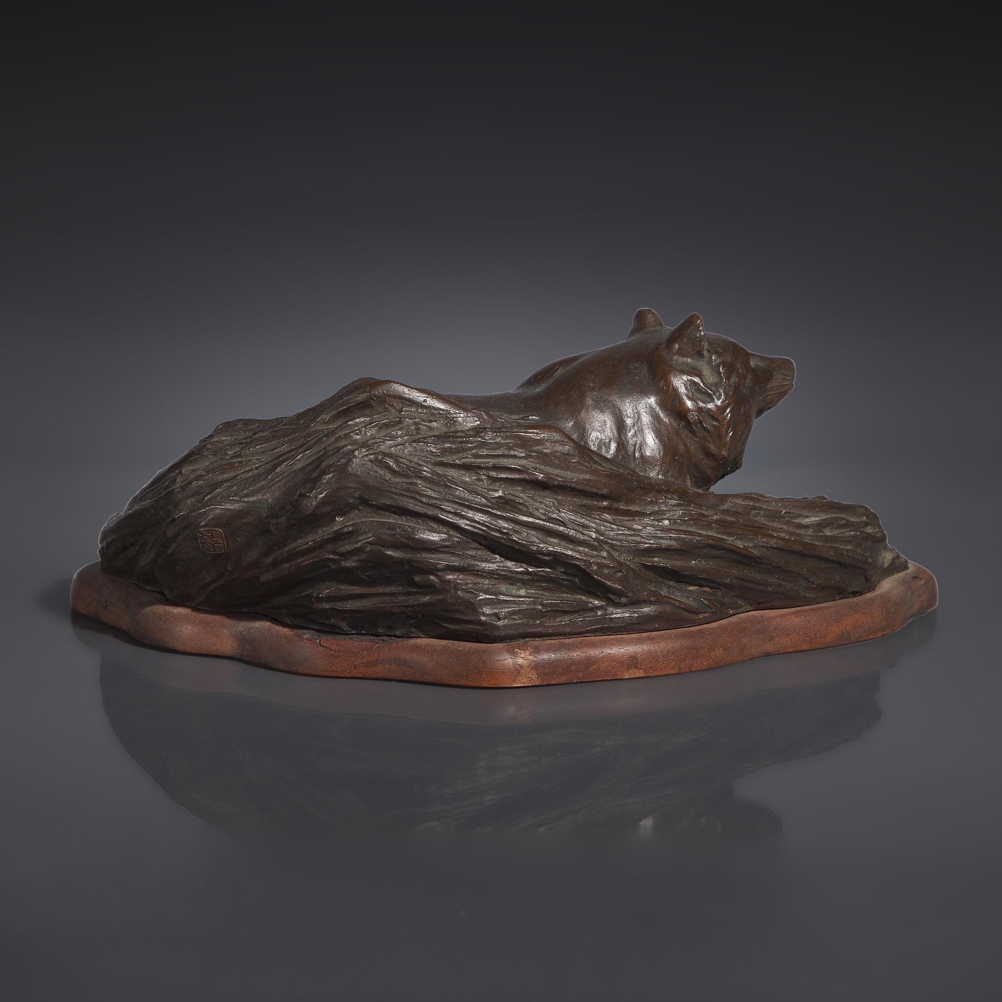 A Japanese Patinated Bronze Figure of a Tanuki in Grasses, Meiji/Taisho Period, The Maruki Co., Tokyo — 日本明治/大正時代 “丸喜製銅”銅狸貓置物
