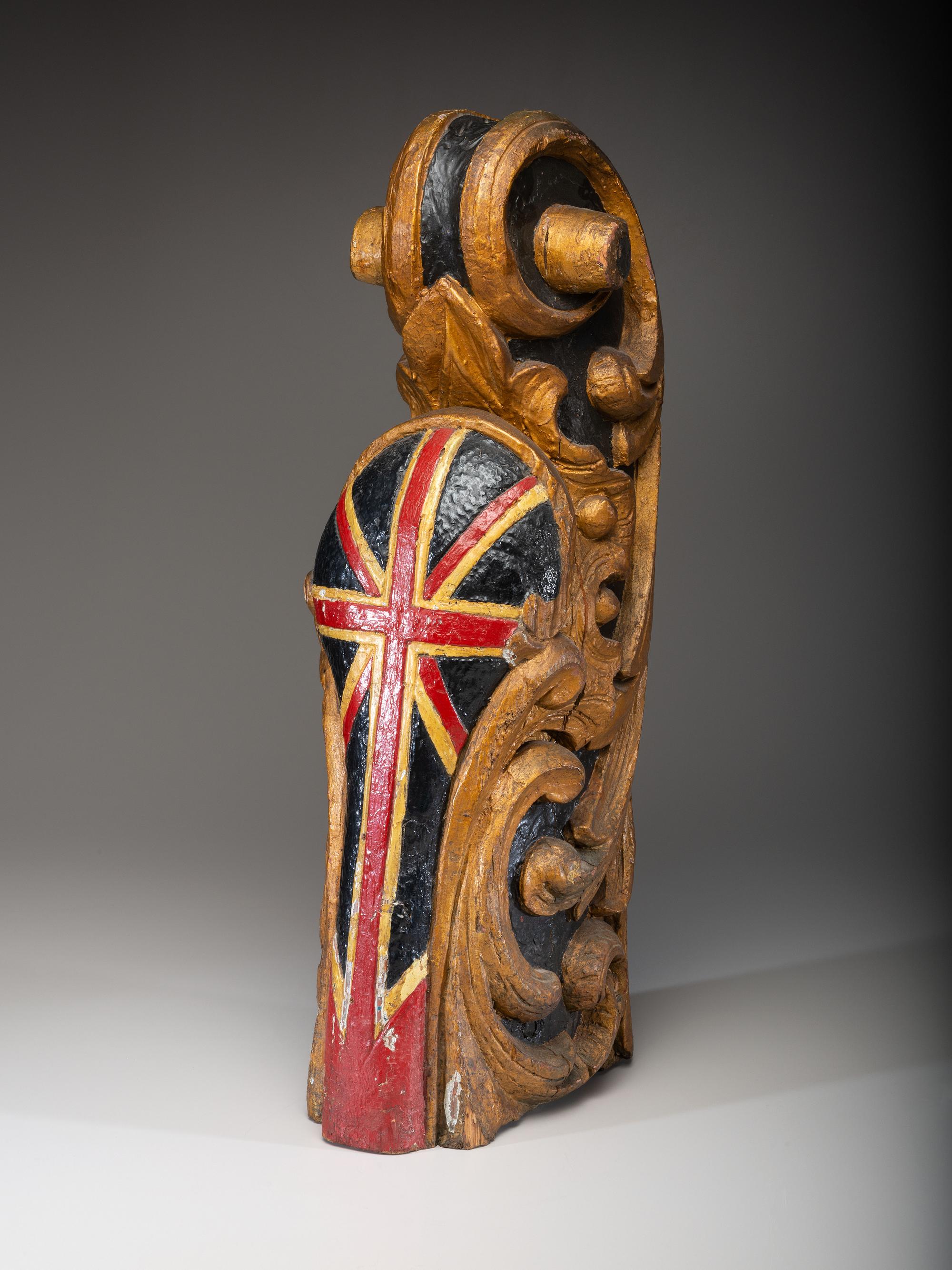 A Carved and Parcel Gilt Union Jack Mast Head