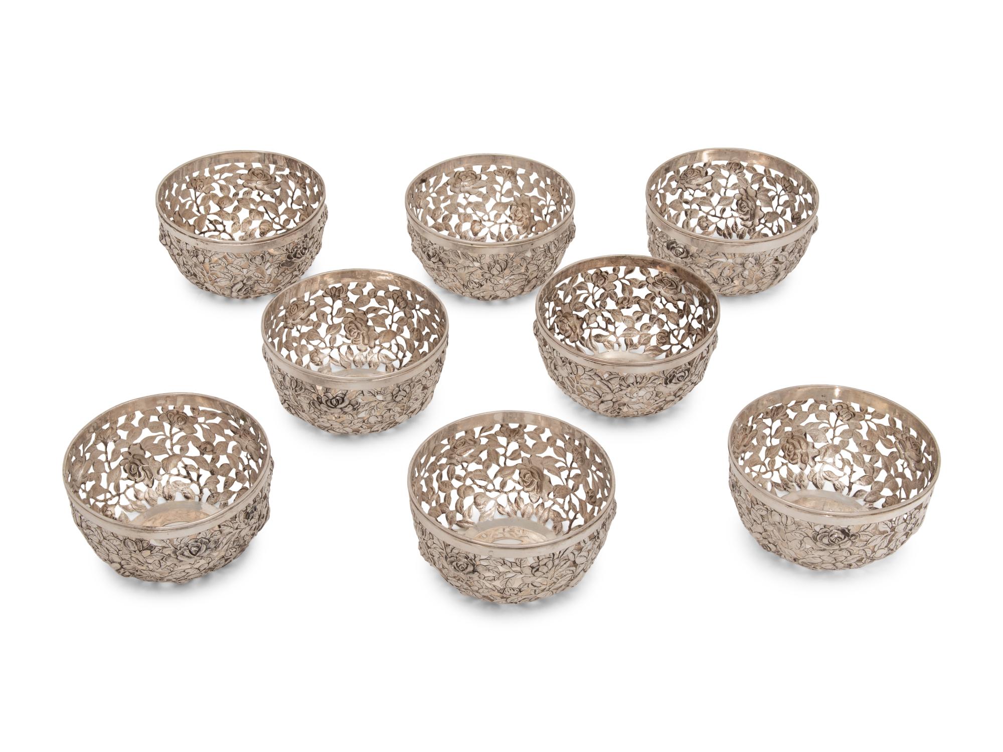 A Set of Eight Chinese Export Pierced Silver Bowl Liners