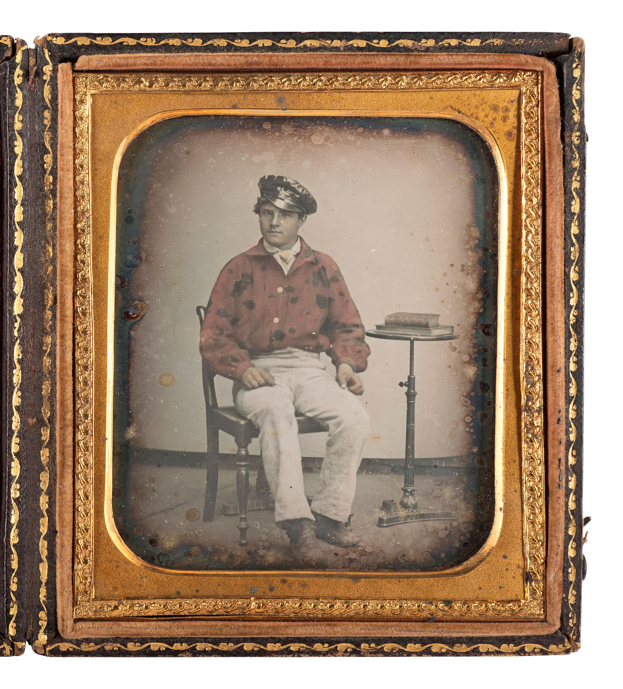 [EARLY PHOTOGRAPHY - MILITARIA]. Sixth plate daguerreotype of a possible fireman wearing a red-tinted jacket, possibly identified.