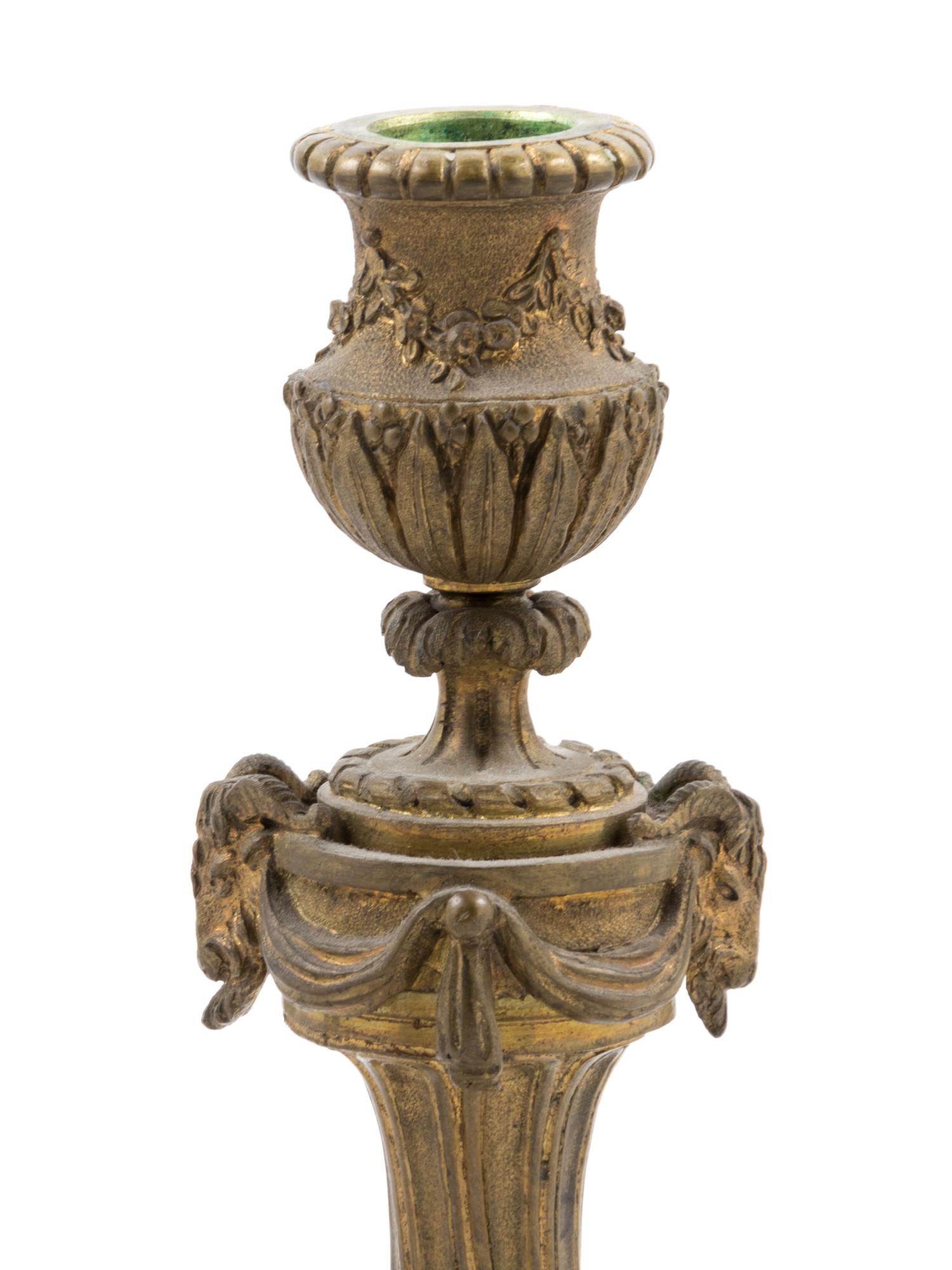 A French Gilt Bronze Candlestick and Figural Mirror