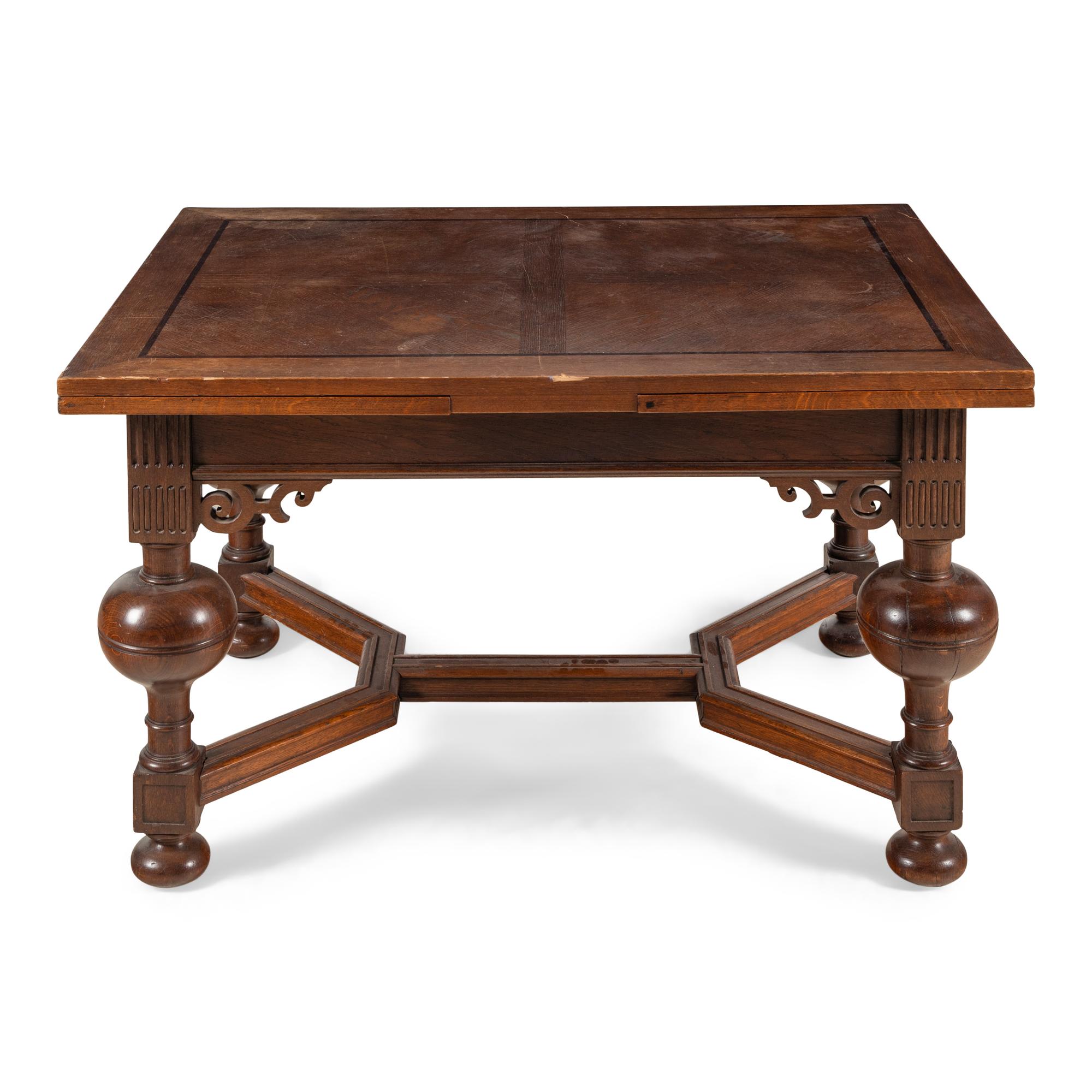 A Baroque Style Oak Draw-Leaf Dining Table
