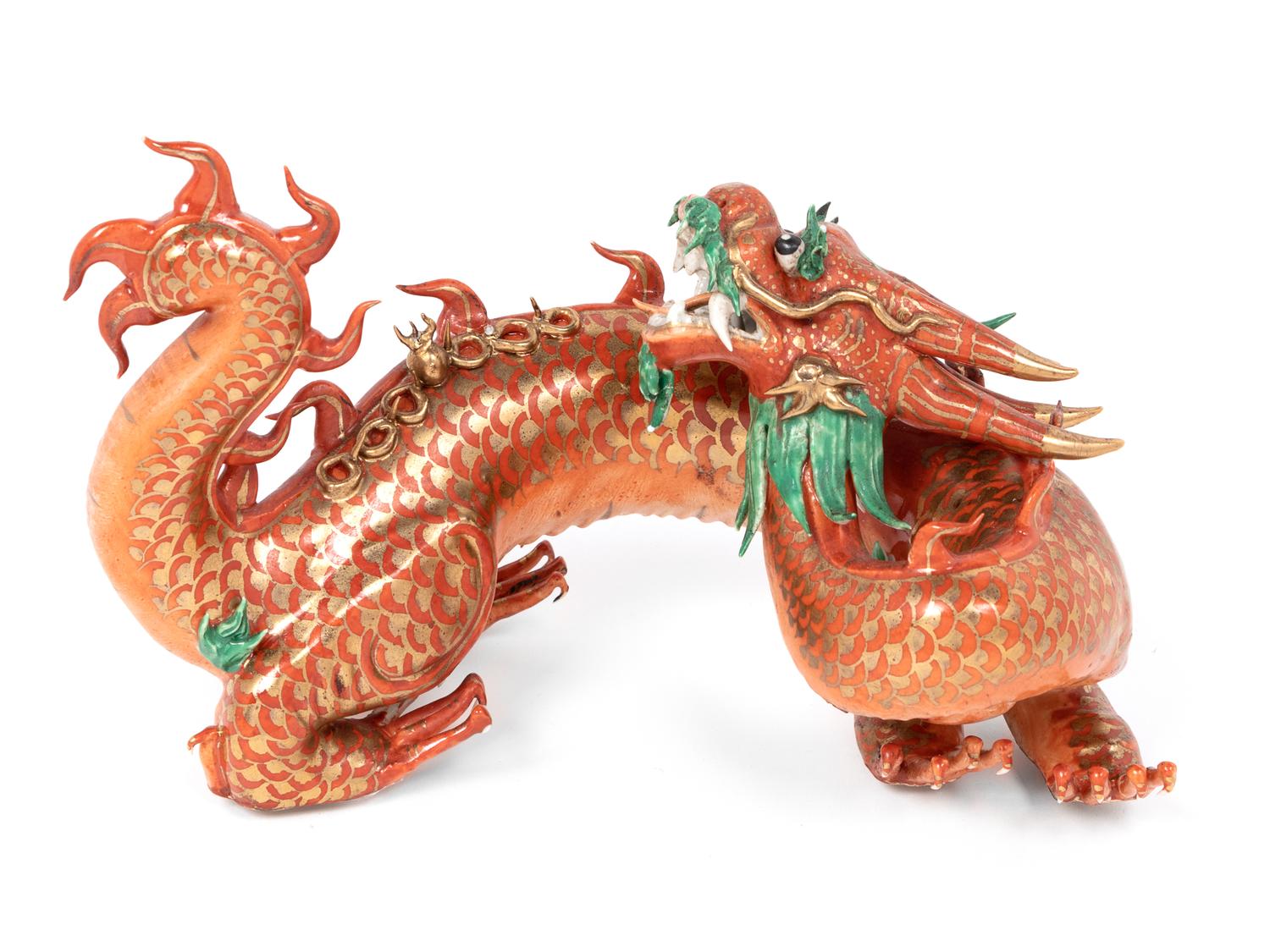 A Chinese Coral Red Ground Gilt and Green Enameled Porcelain Figure of Dragon