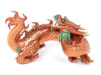 A Chinese Coral Red Ground Gilt and Green Enameled Porcelain Figure of Dragon