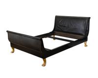 An Empire Style Ebonized and Gilt Wood Sleigh Bed — 20TH/21ST CENTURY