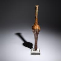 A Roman Aubergine Glass Unguentarium
