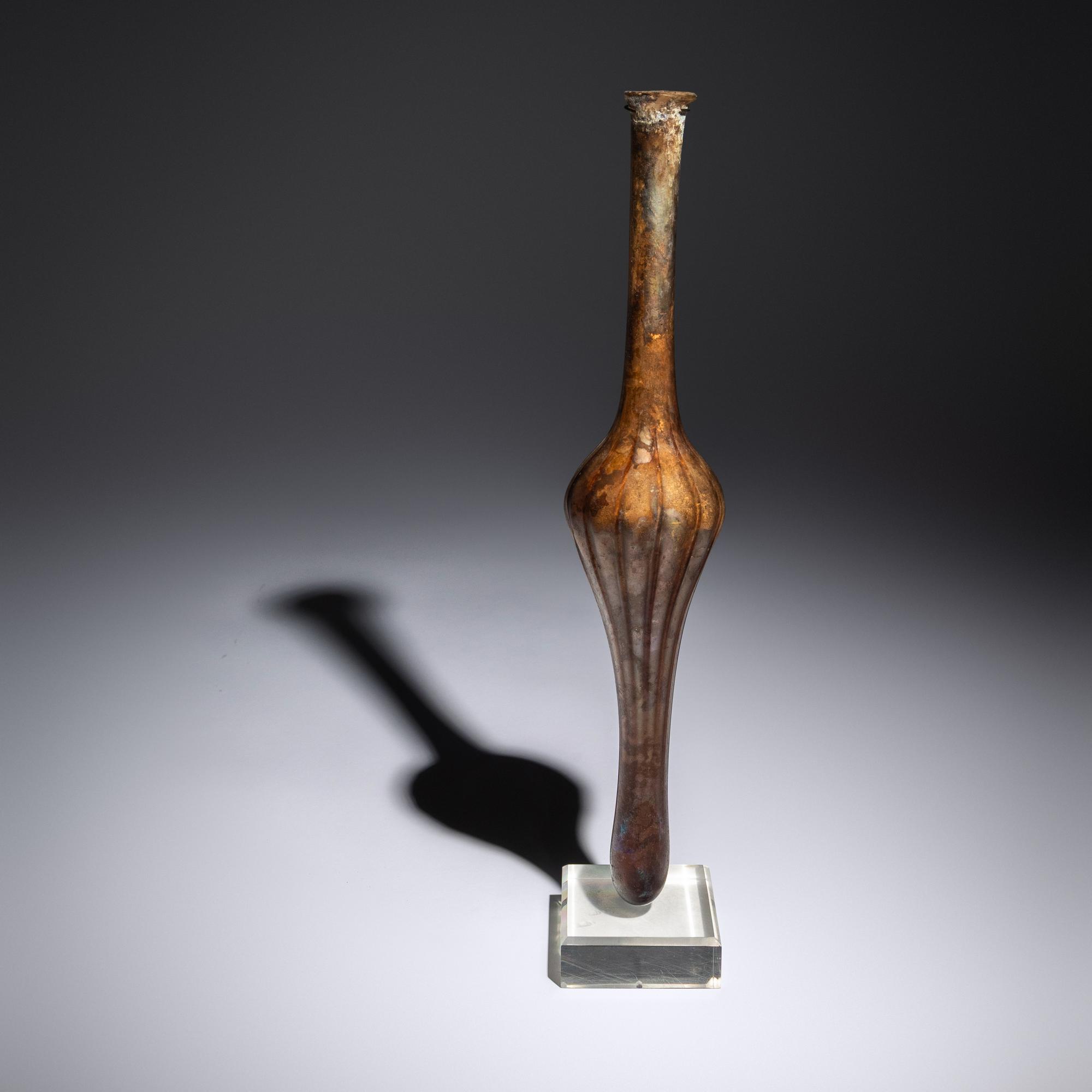 A Roman Aubergine Glass Unguentarium