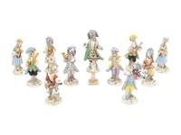 An Assembled Group of Twelve Continental Porcelain Dog Band Figures