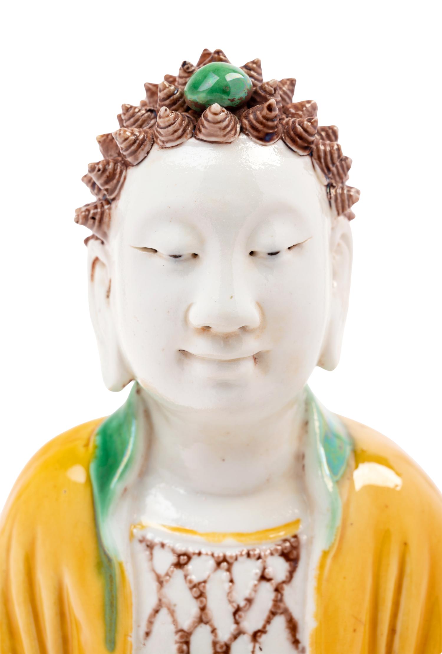 A Chinese Sancai Glazed Biscuit Figure of Buddha Shakyamuni