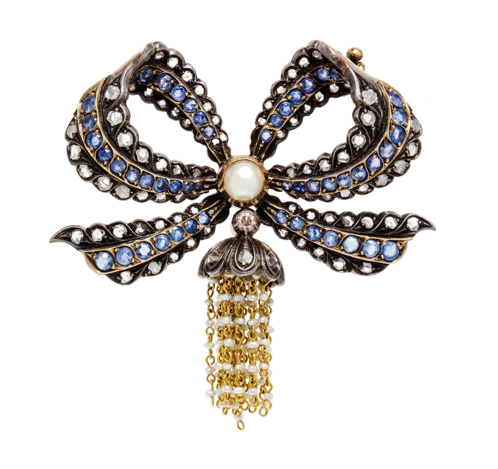An Antique Silver Topped Yellow Gold, Diamond, Sapphire and Pearl Bow Brooch, 14.00 dwts.