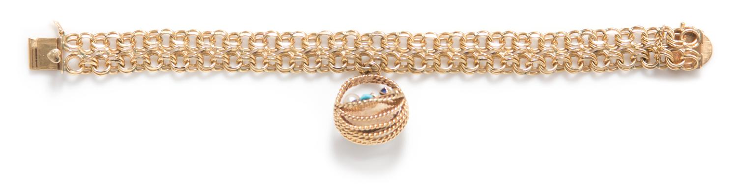 A 14 Karat Yellow Gold, Cultured Pearl, Sapphire, Ruby and Turquoise Charm Bracelet, 28.80 dwts.