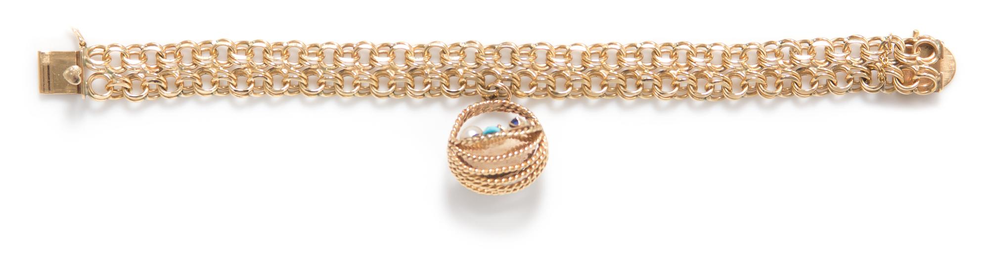 A 14 Karat Yellow Gold, Cultured Pearl, Sapphire, Ruby and Turquoise Charm Bracelet, 28.80 dwts.