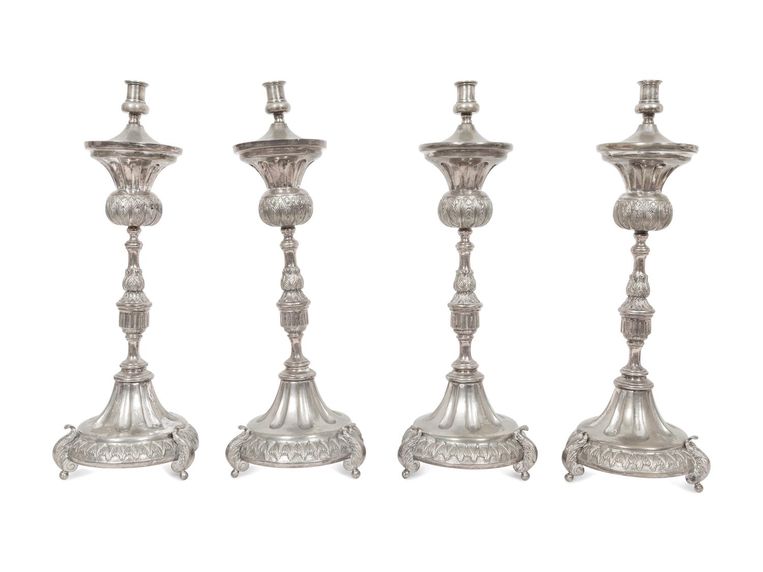 A Set of Four Continental Silvered Metal Candlesticks