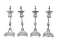 A Set of Four Continental Silvered Metal Candlesticks