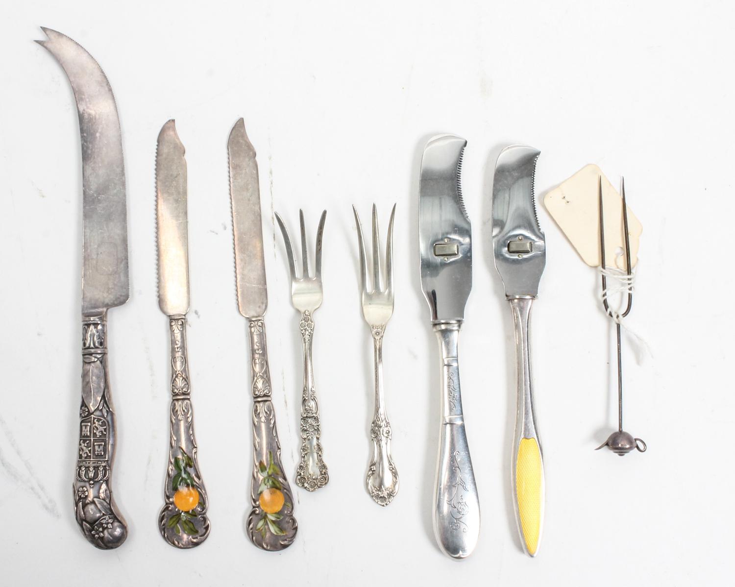 A Collection of Silver Flatware Articles, various makers, comprising three silver-handled cheese knives, two lemon forks, two enamel de