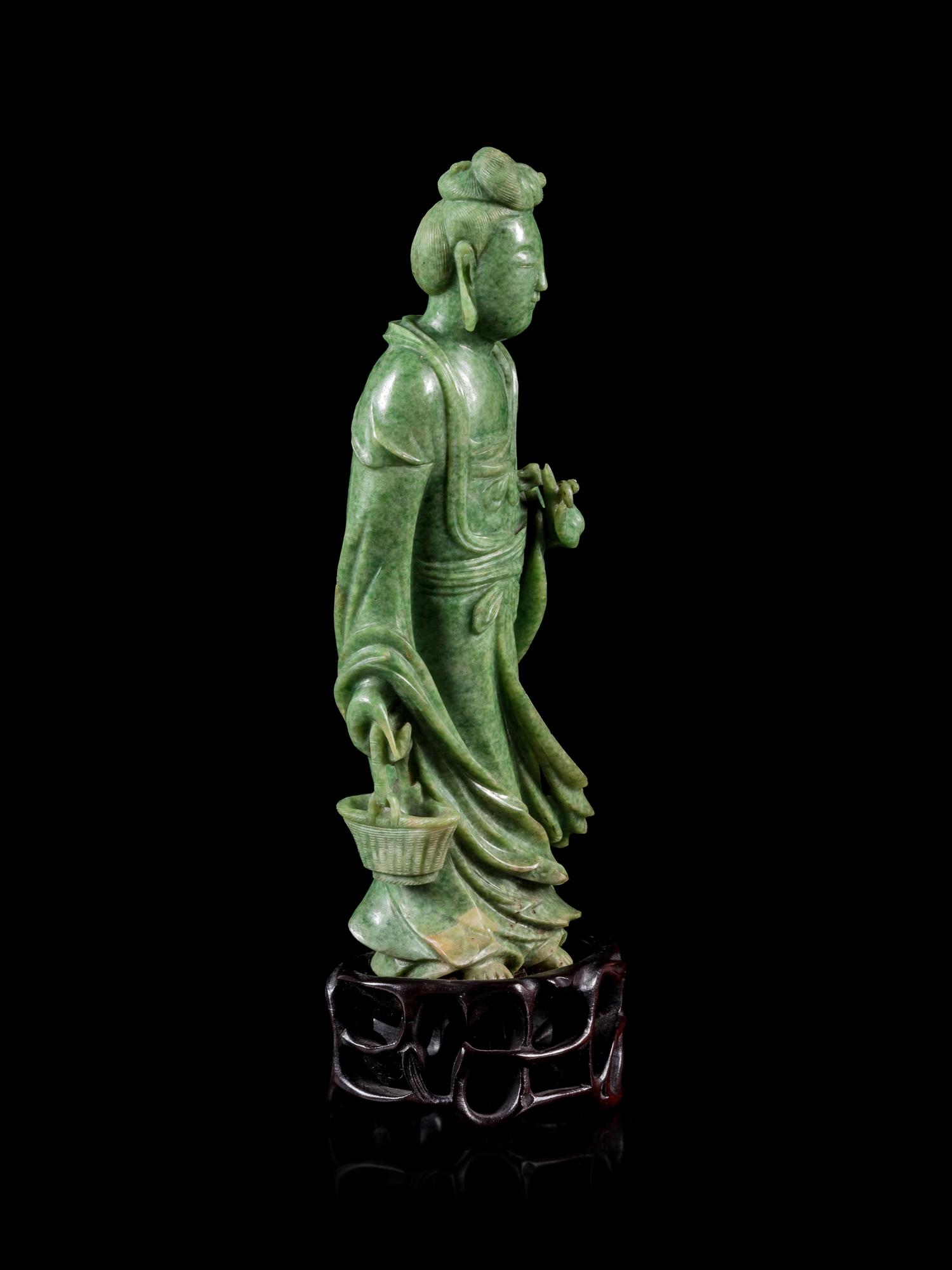 A Mottled Green Jade Figure of Guanyin