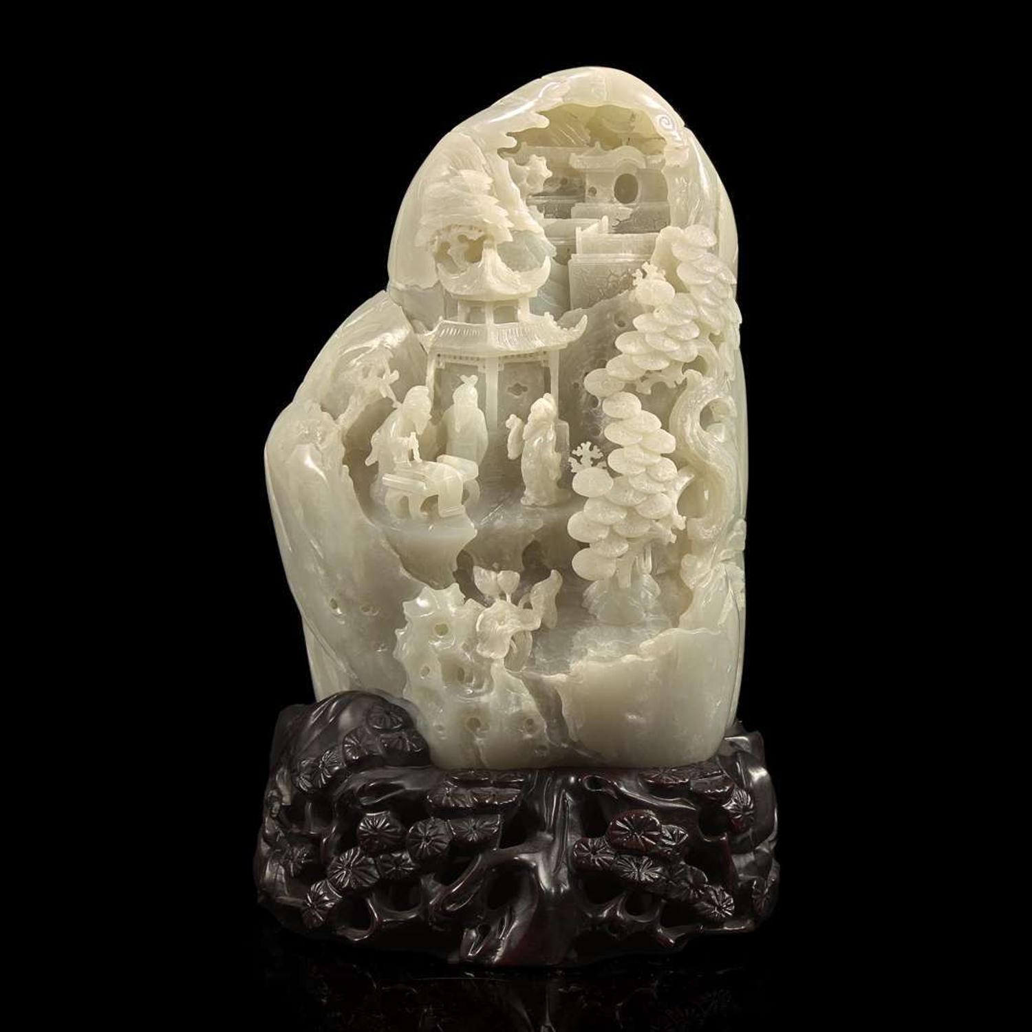 A Chinese carved greyish-white jade "Mountain" and carved wood stand 灰白玉山子及木底座 20th century ????